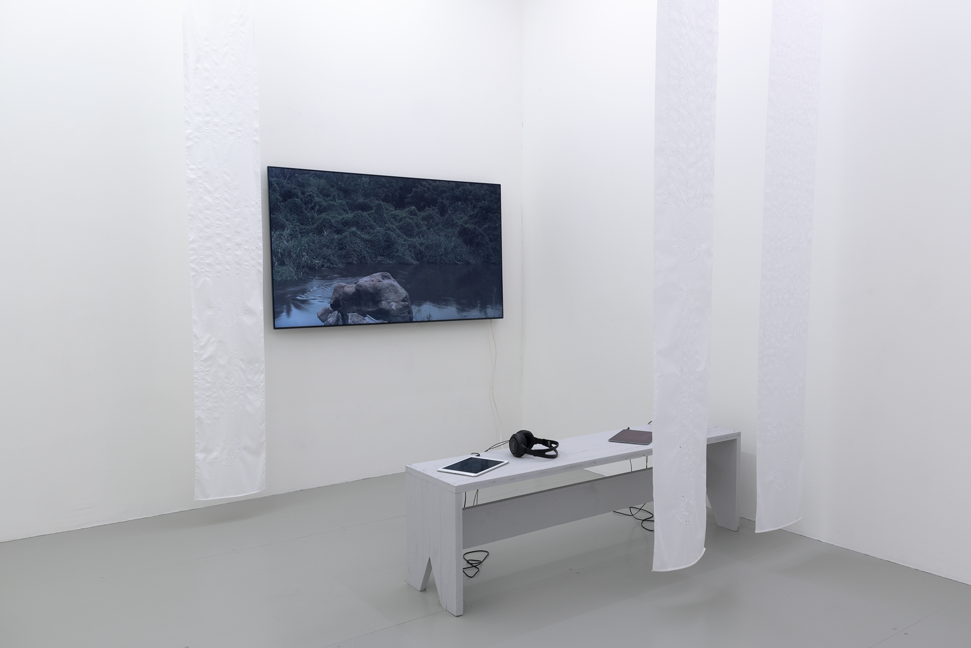 Denise Bertschi. Helvécia, Brazil, 2017/2020. Group of three works: HD video, sound, loop, 20 mins; Two-channel HD video, sound, loop, 20 mins; Eyelet embroidery on cotton, 3 textile pieces, 10 meters each.