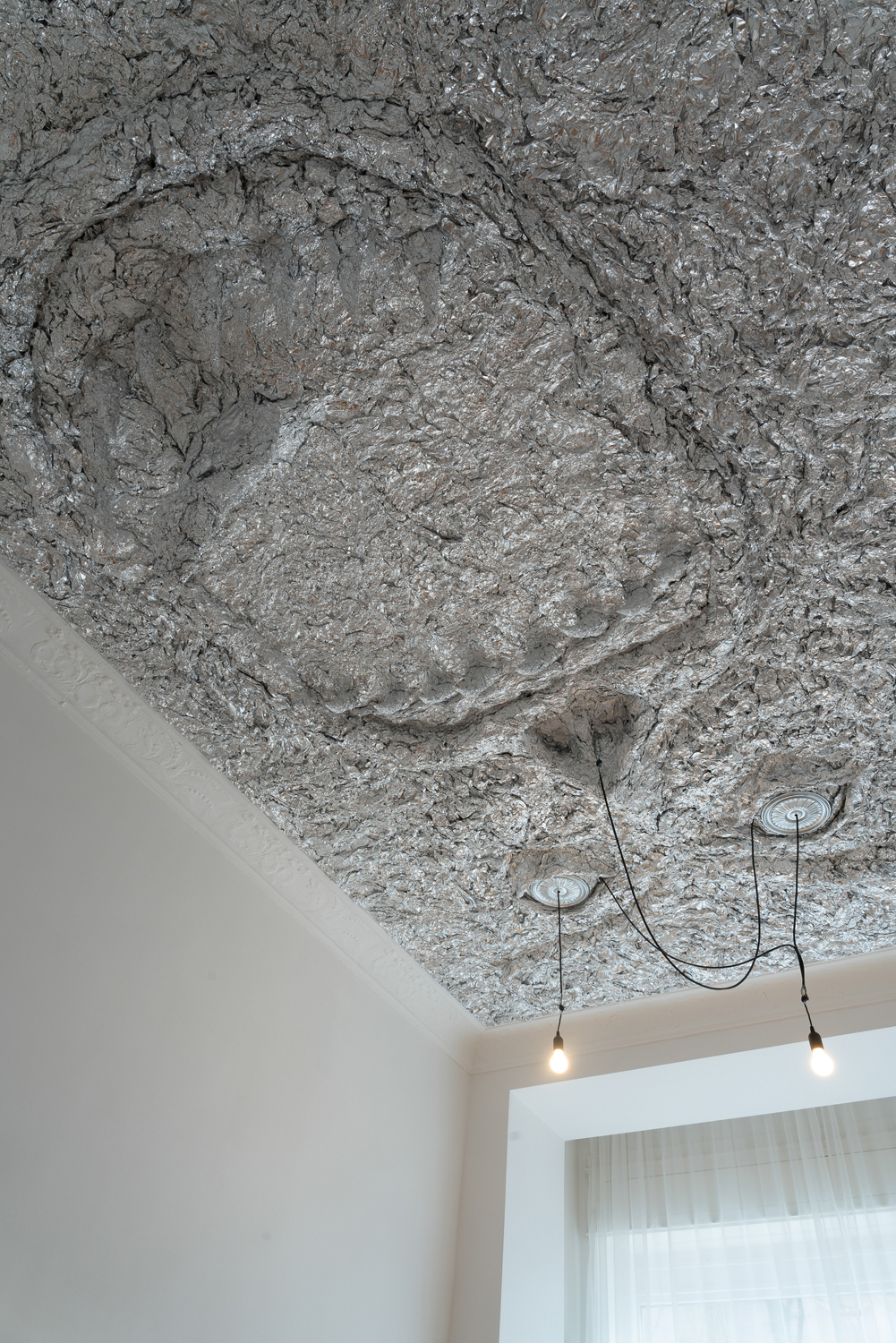 Tobi Keck, Lurer, 2022, Aluminium foil, stucco rosettes, light bulbs, building’s electricity infrastructure, 3.2m x 5.2m x 0.8m, View 4