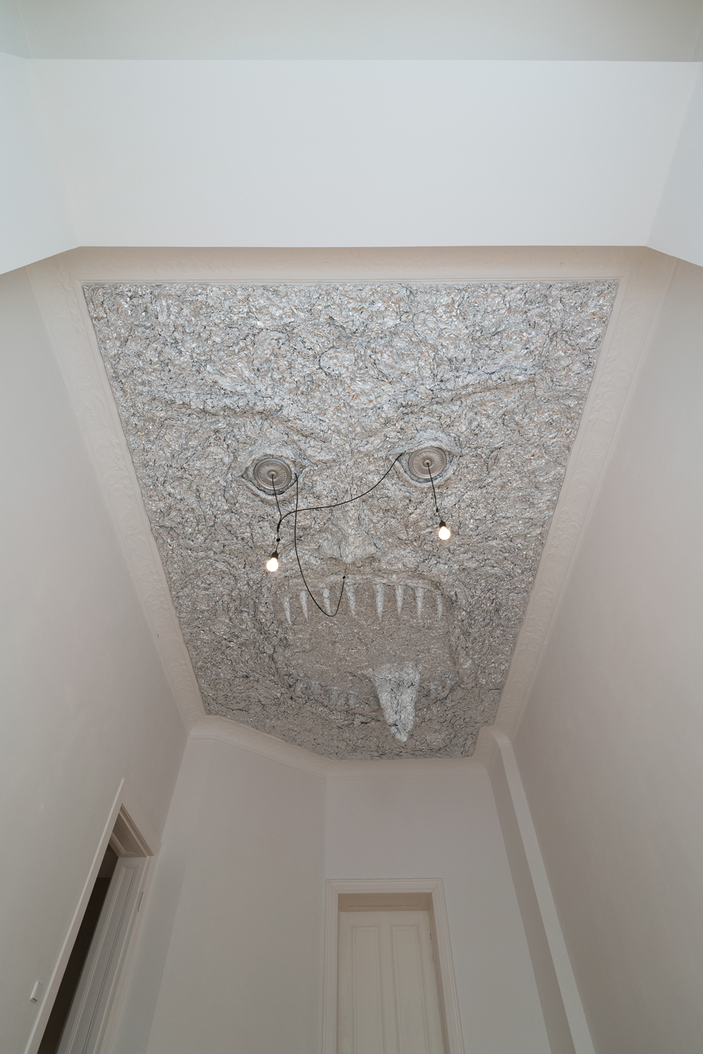 Tobi Keck, Lurer, 2022, Aluminium foil, stucco rosettes, light bulbs, building’s electricity infrastructure, 3.2m x 5.2m x 0.8m, View 1