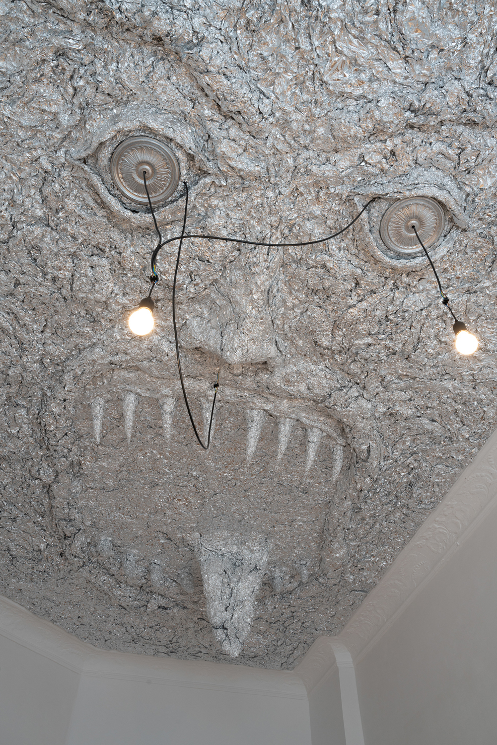 Tobi Keck, Lurer, 2022, Aluminium foil, stucco rosettes, light bulbs, building’s electricity infrastructure, 3.2m x 5.2m x 0.8m, View 2