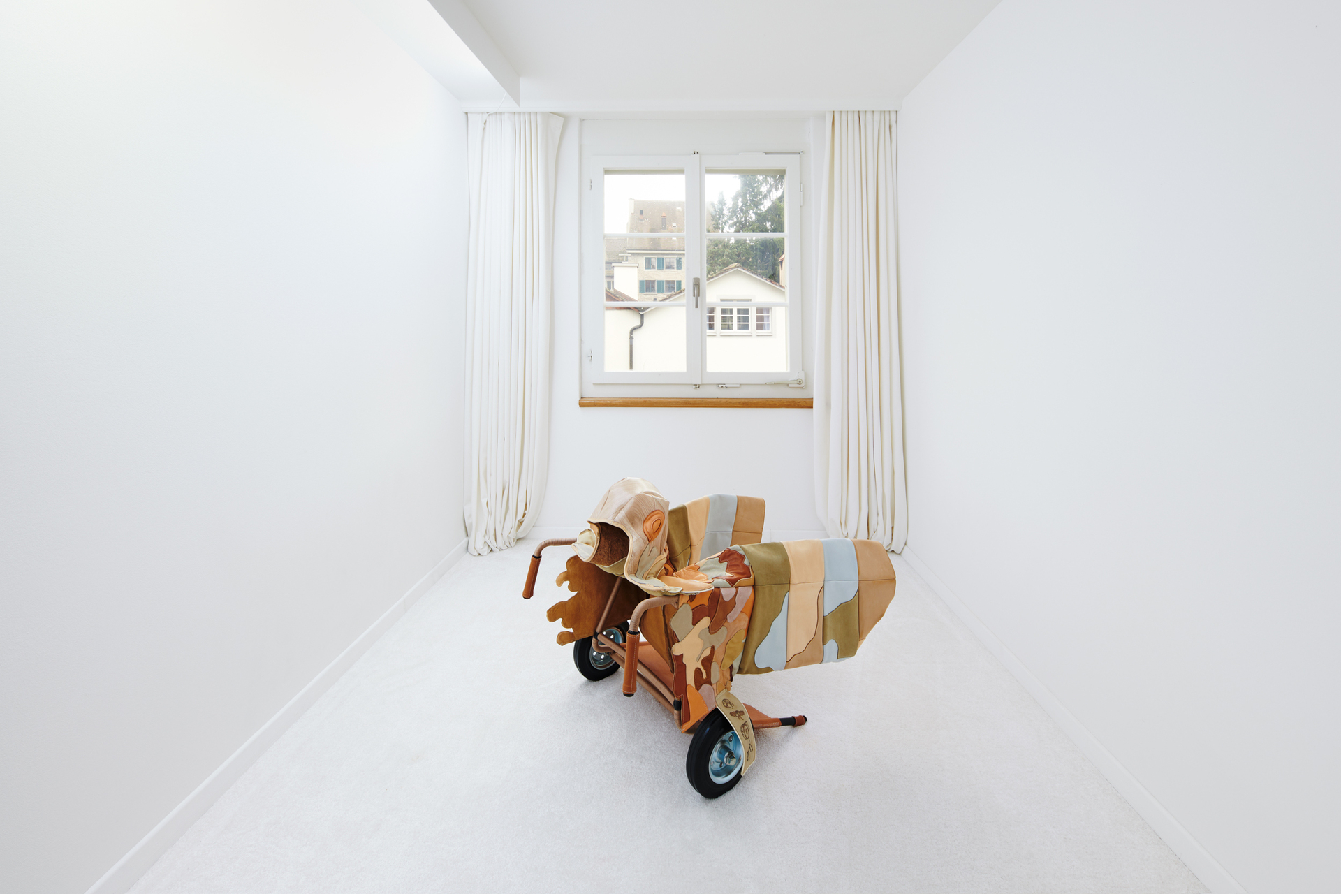 Hansol Kim, MobileShortJacketShield ,2020, Leather, wooden mat, chair frame, piping cord, wax-coated thread, wheels, leather lace, cork fabric, snap button 70 x 64.5 x 89 cm