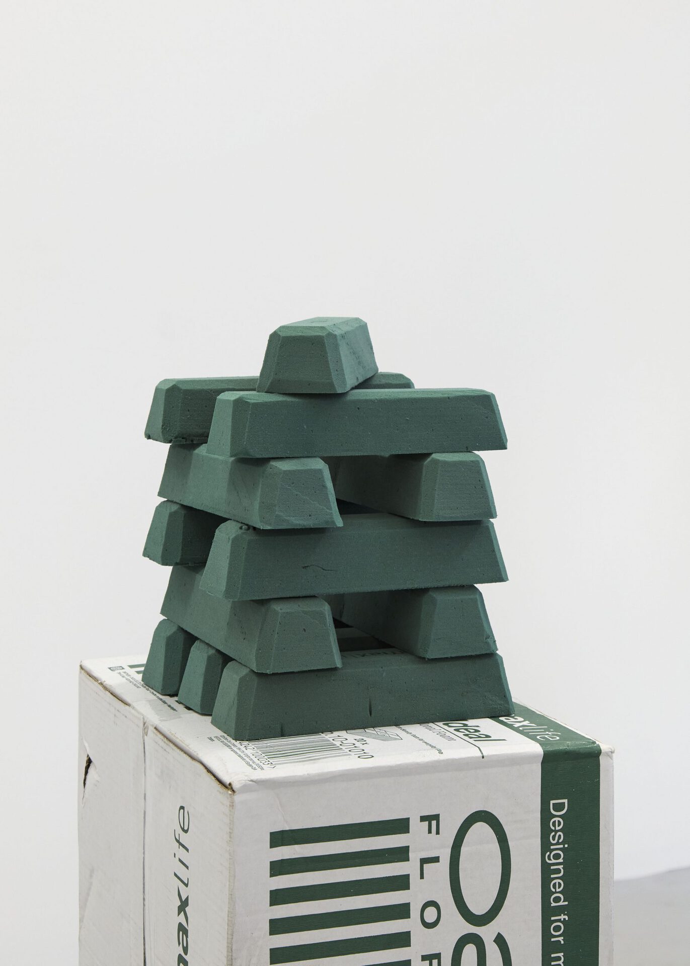 Max Petts, MAX|LIFE, 2022, ardboard, sellotape, phenol-formaldehyde bricks, cinder block, floral wire, looped audio, sticker, 32 x 24 x 116cm approx.