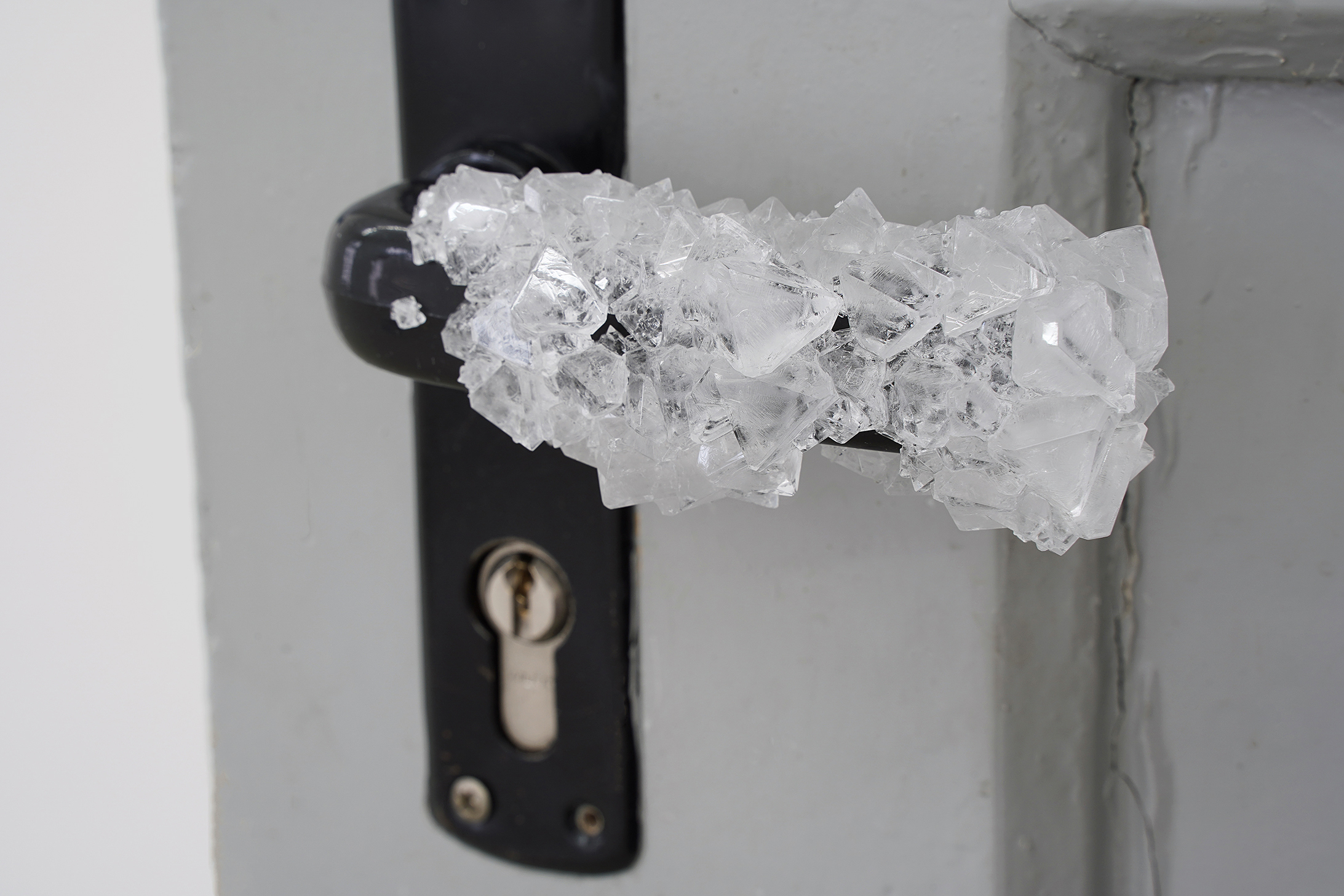 Mika Schwarz, Sarabande, 2022, Aluminum potassium sulfate (door handle), variable size