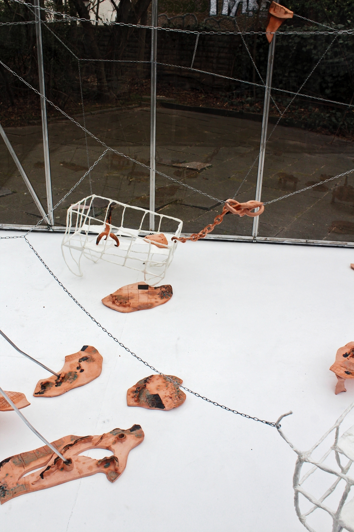 Anna Bochkova, Space Cradle, 2022, ceramics, papier-mâché, steel chains, aluminum pipes, variable dimensions, installation view