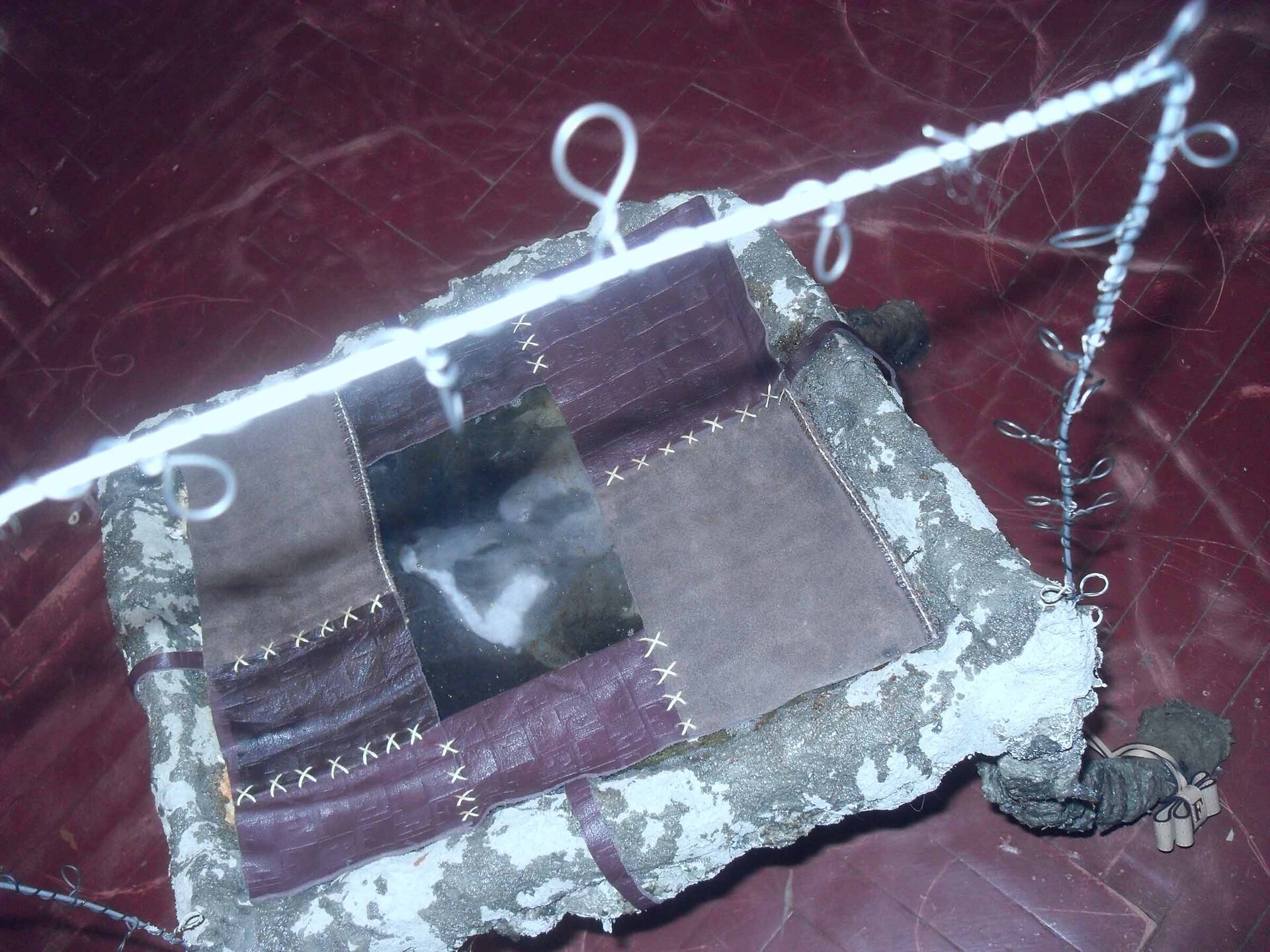 Smart system #7, 2022, concrete, epoxy resin, cow leather, metal wire, 66 × 102 × 34,5 cm