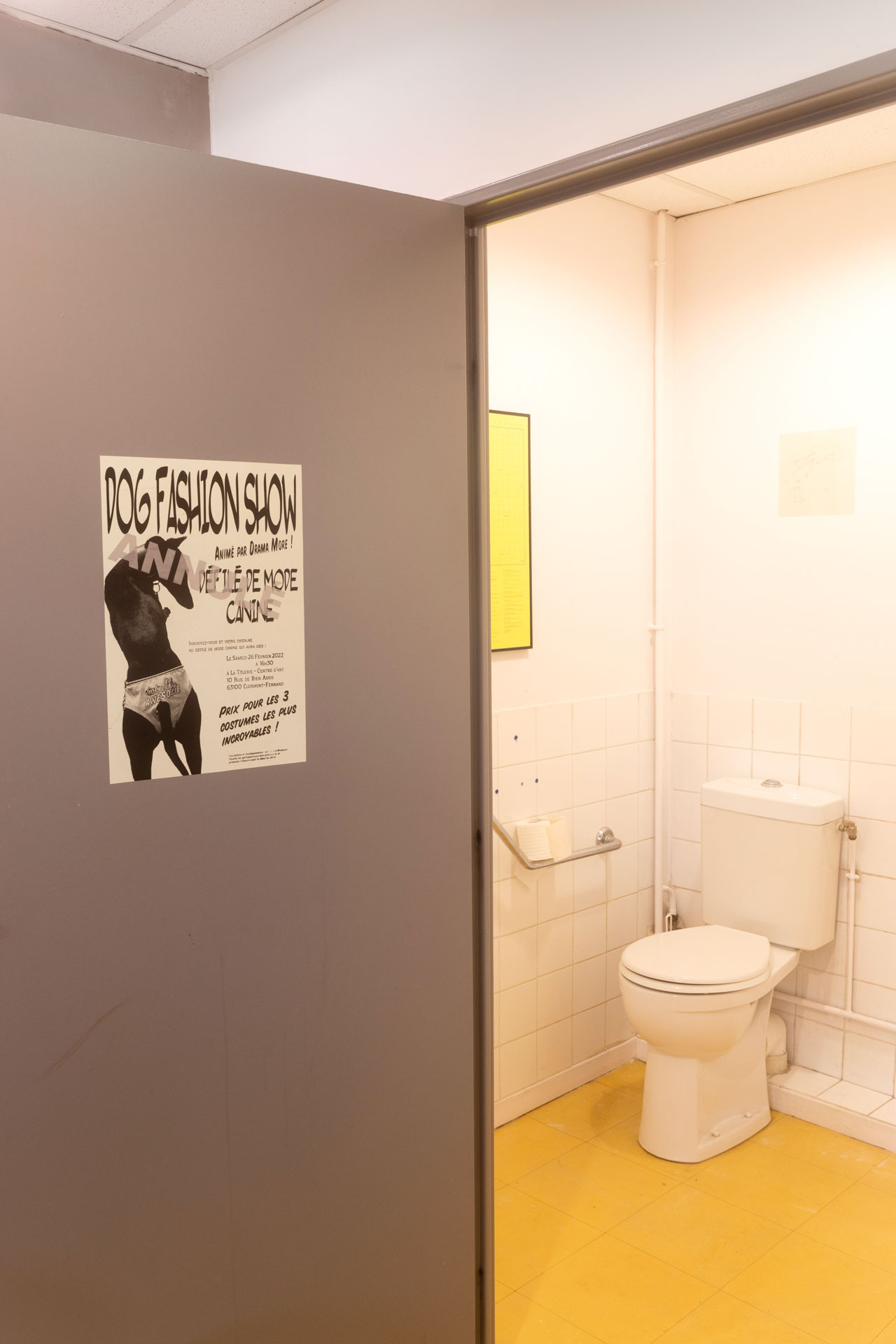 021 - Anouchka Oler Nussbaum - Exhibition view - Silkscreened poster for a cancelled dog fashion show displayed in the toilet of the space.