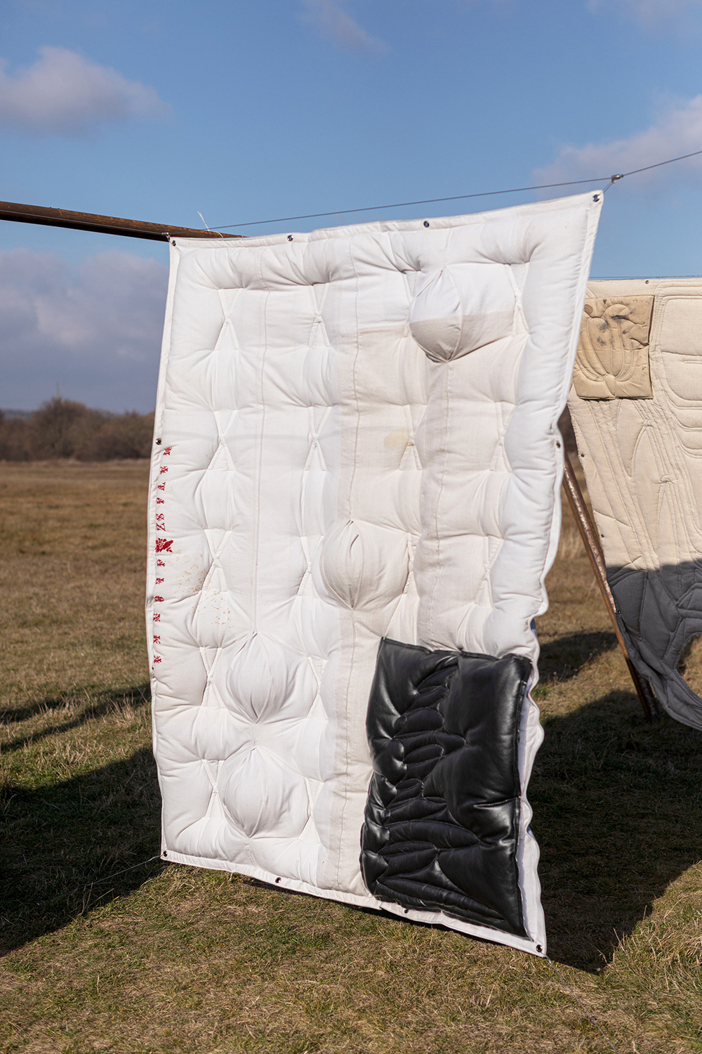 Adrian Kiss, Dunyha Firka 1, 2021, quilted leather and canvas with acrylic spheres, 200 × 140 cm