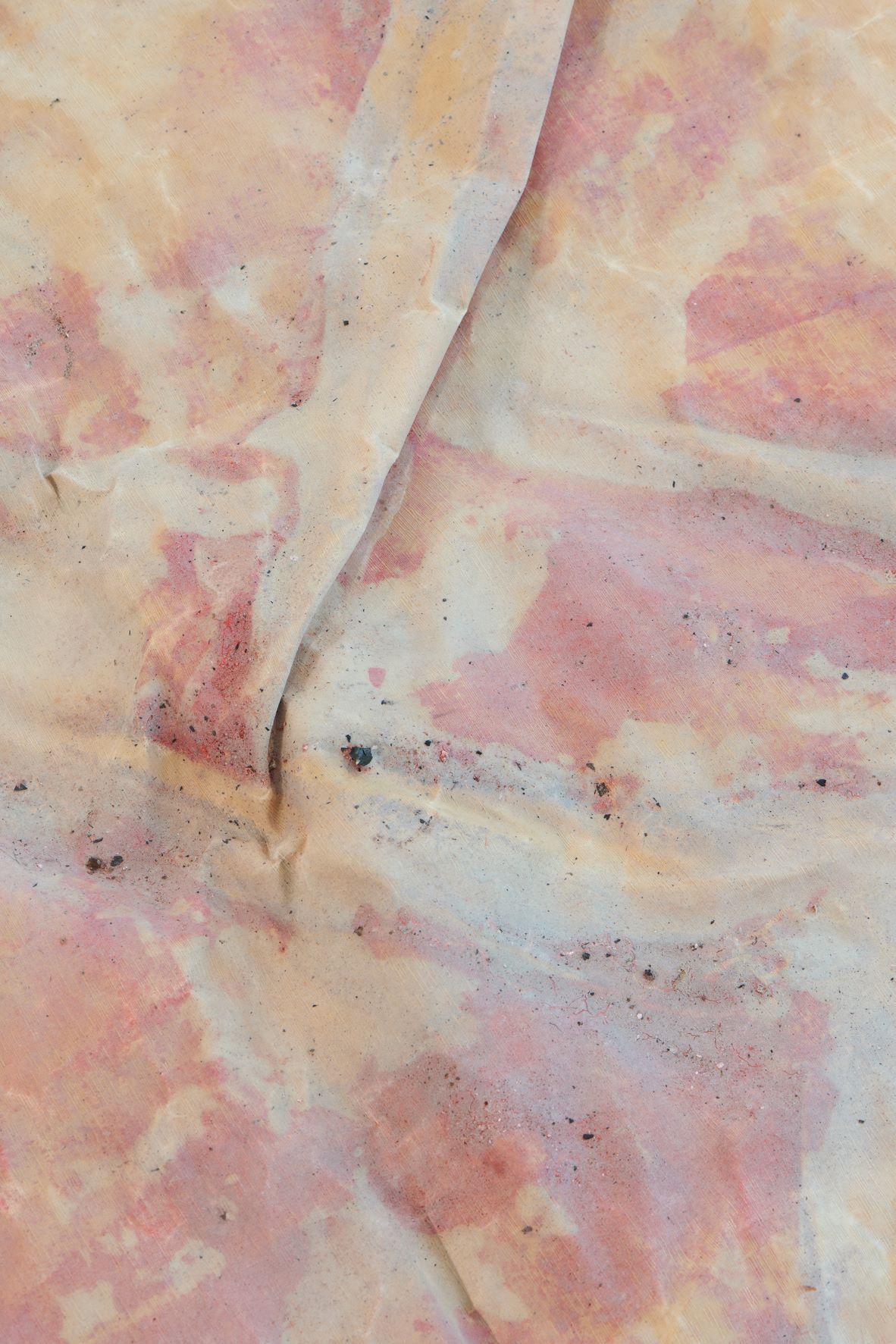 Dala Nasser: Red in Tooth, 2020 – 2021 – 2022 (detail). Discarded fabric, buried underground for 2 weeks to 3 months, ash, charcoal, rainwater. Kölnischer Kunstverein, 2022. Courtesy: the artist and Deborah Schamoni. Photo: Mareike Tocha.