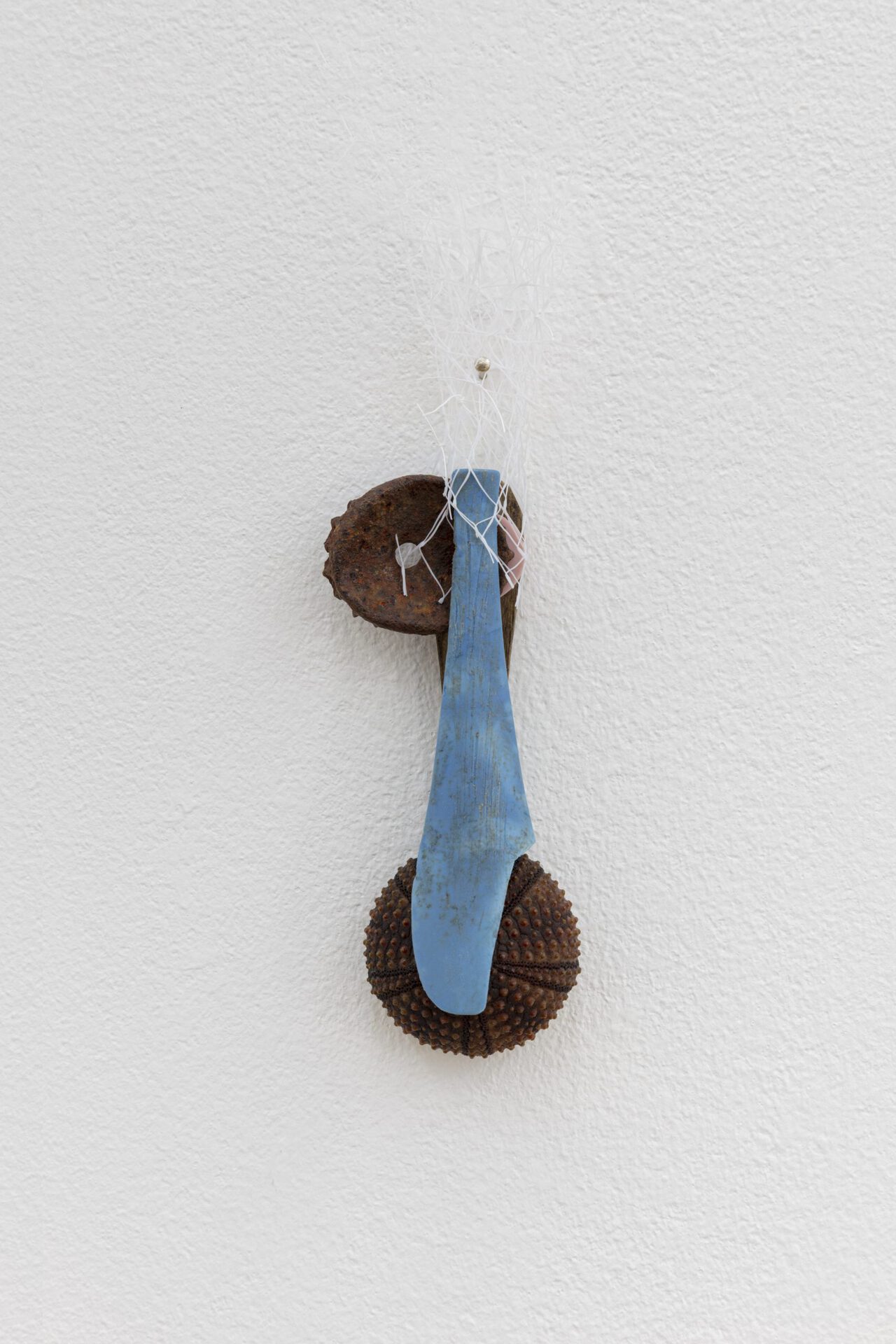 David Fesl, Untitled, 2022, soap sleeve, plastic spoon, popsicle stick, bottle cap, gummy seal, sea urchin shell, 15.4 × 4 × 2 cm