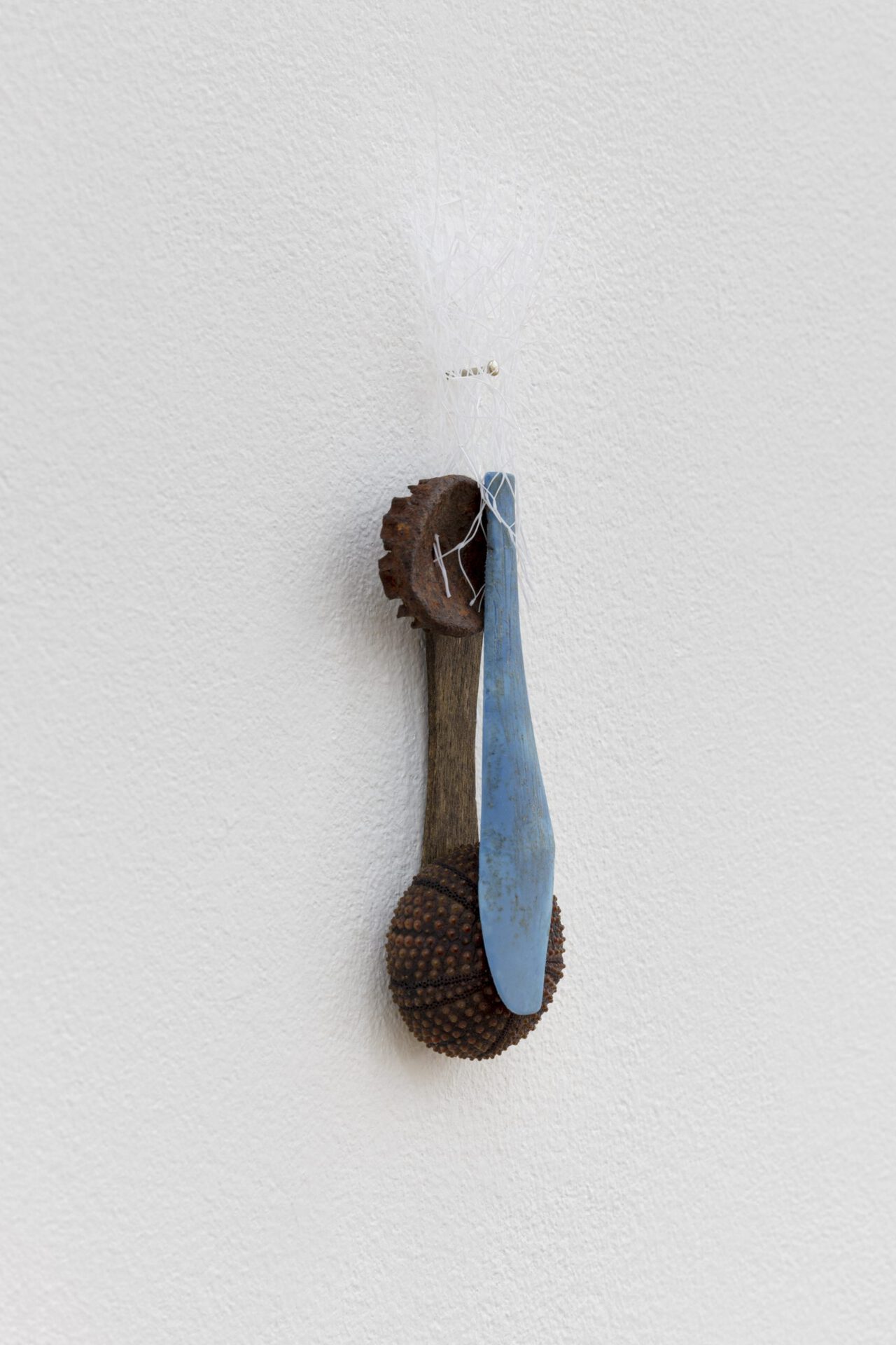 David Fesl, Untitled, 2022, soap sleeve, plastic spoon, popsicle stick, bottle cap, gummy seal, sea urchin shell, 15.4 × 4 × 2 cm