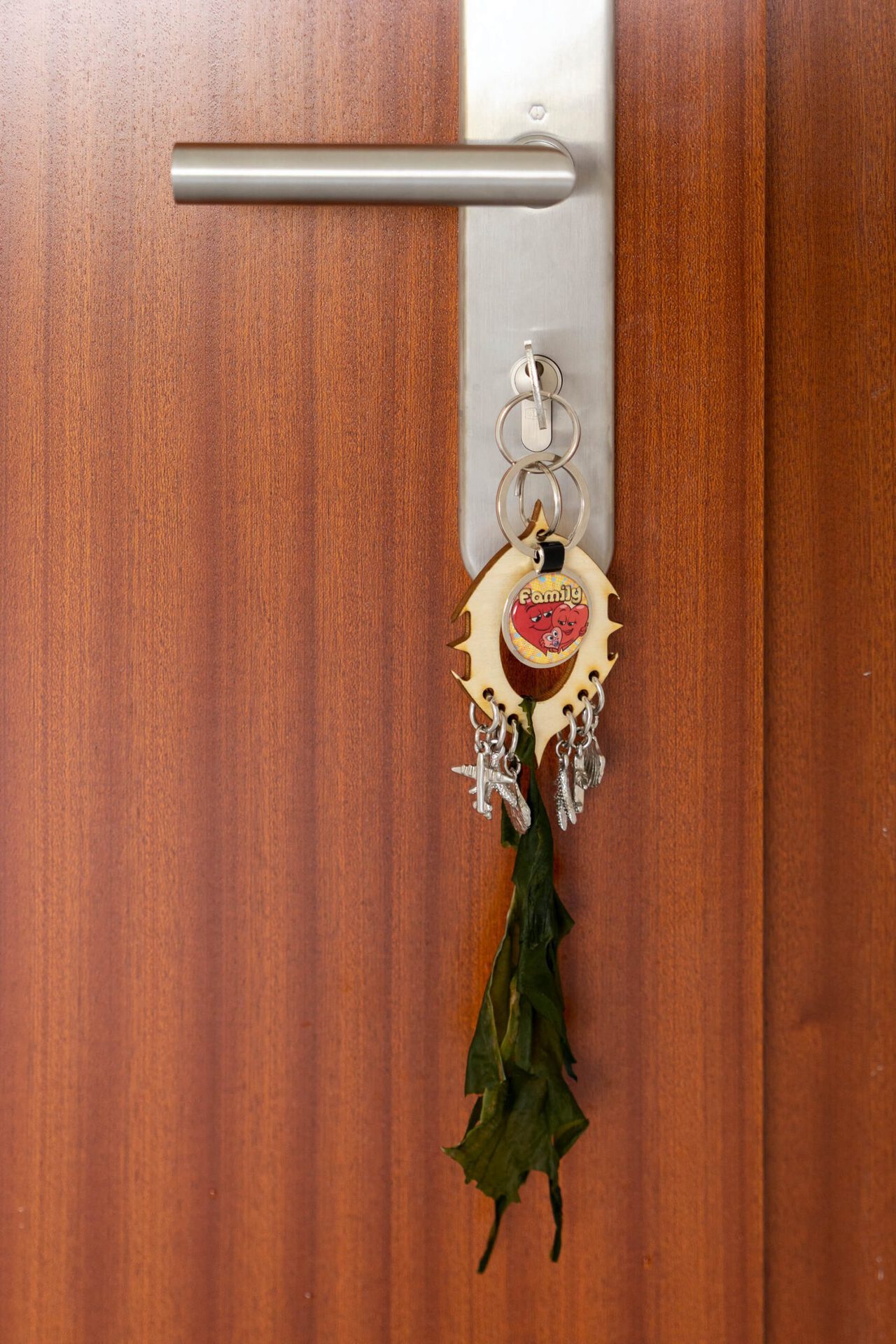Theresa Weisheit, a quick cigarette by the beach while the baby is asleep, installation view 1, 2022, layered wood, keychain, 6 x 20 x 1 cm
