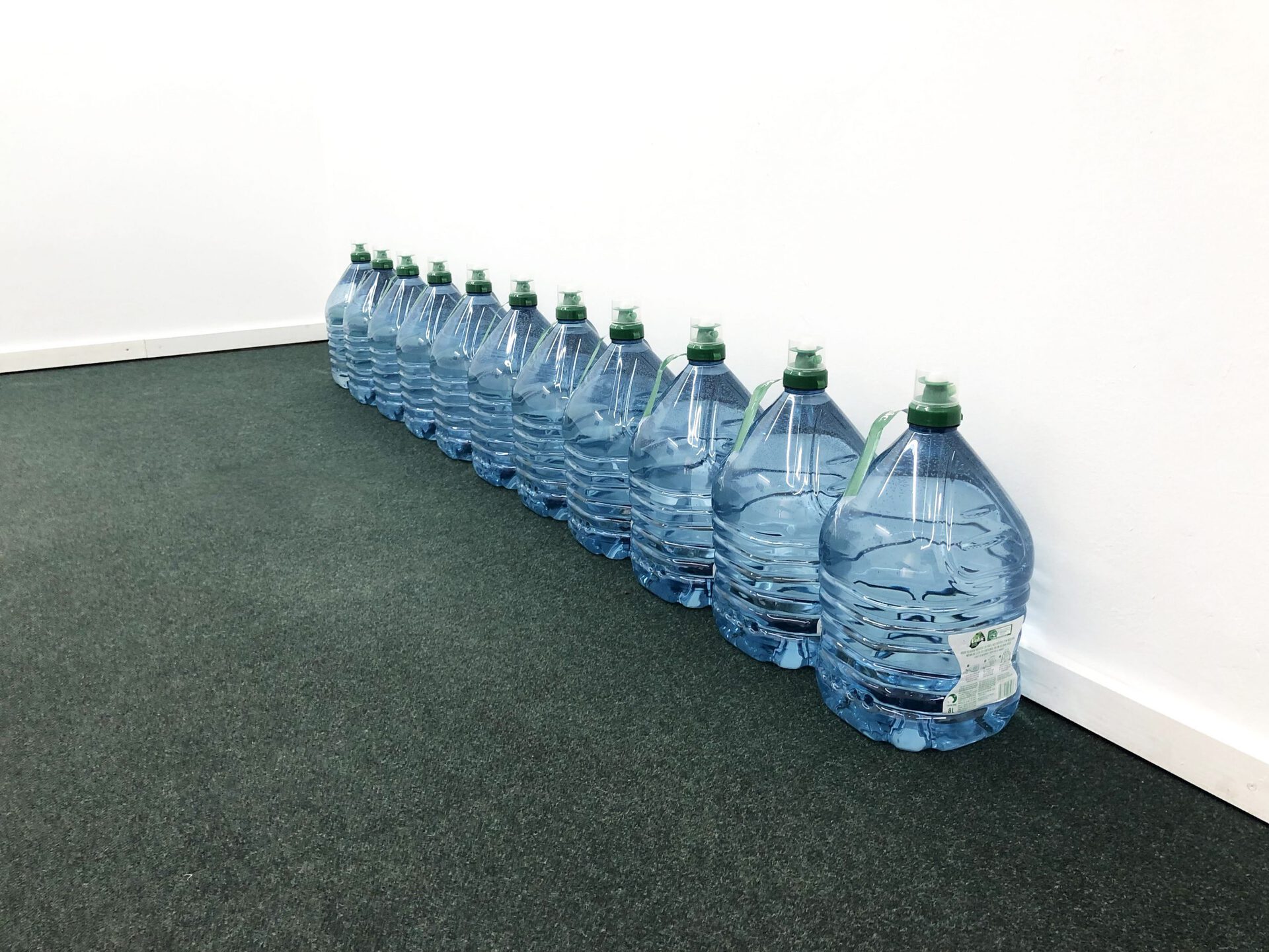 Philip Newcombe, Social Water, 2022, Water from 8-litre bottles of water exchanged between each other. Dimensions, volume and amounts of contained water are variable...