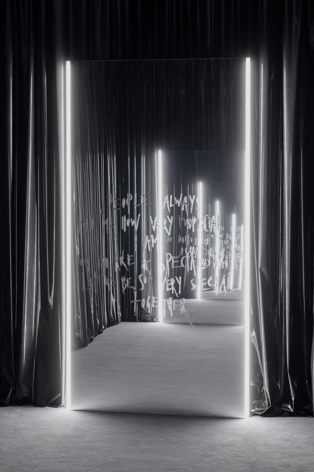 Julian-Jakob Kneer, PEOPLE ALWAYS TOLD ME HOW VERY SPECIAL I AM. YOU TOO ARE A SPECIAL ONE. LET US BE SO VERY SPECIAL TOGETHER. 2022, Mirror foil on alu-frame, lipstick, LED lights, metal lacquer on vinyl curtain, mirror: 298 x 156 x 4 cm; curtain: variable dimensions