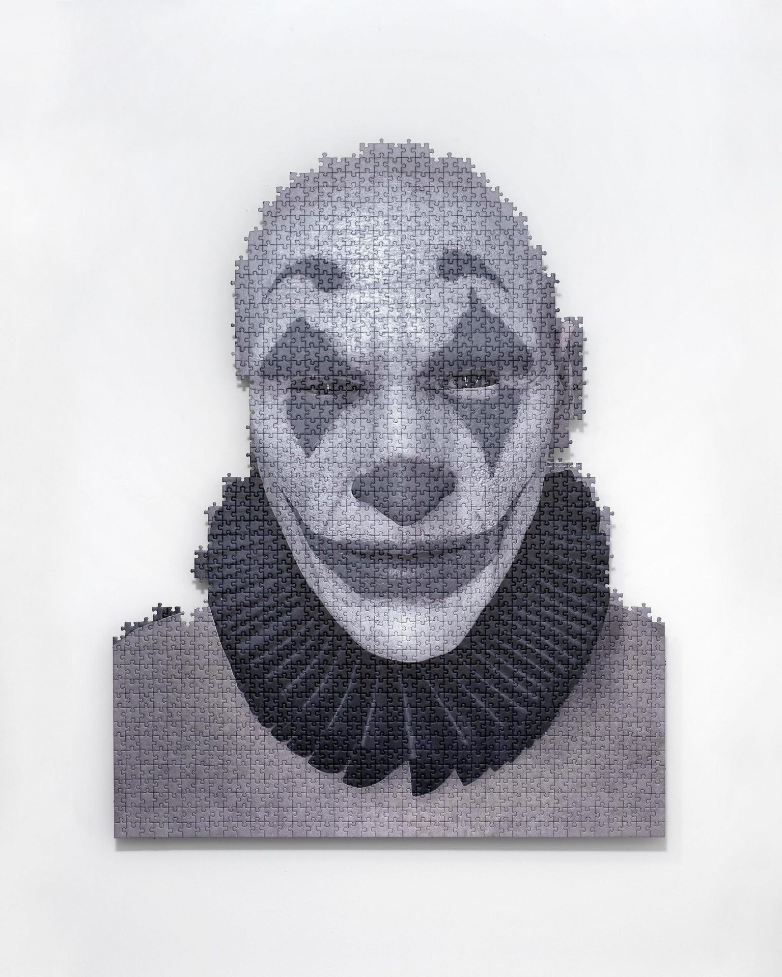 Julian-Jakob Kneer, DER MANN DER LACHT, 2022, digital print on puzzle, aluminium construction, 94,5 x 75,5 x 5,5 cm