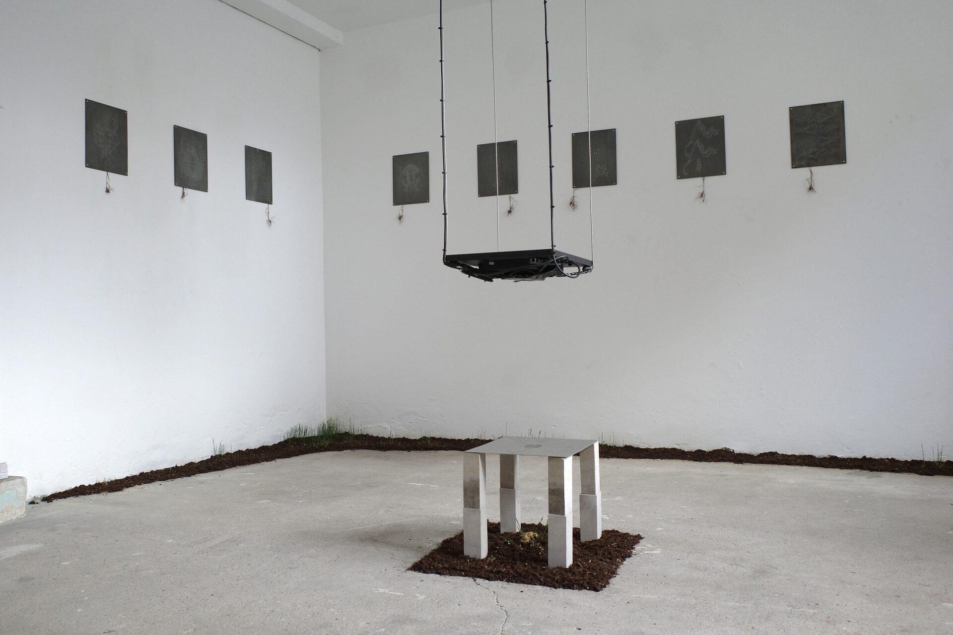 Anders Aarvik, untitled (interface), 2022, laser-engraved steel, limestone, monitor, AR, wire, soft clay, soil, wheat seeds, 37x31x300cm