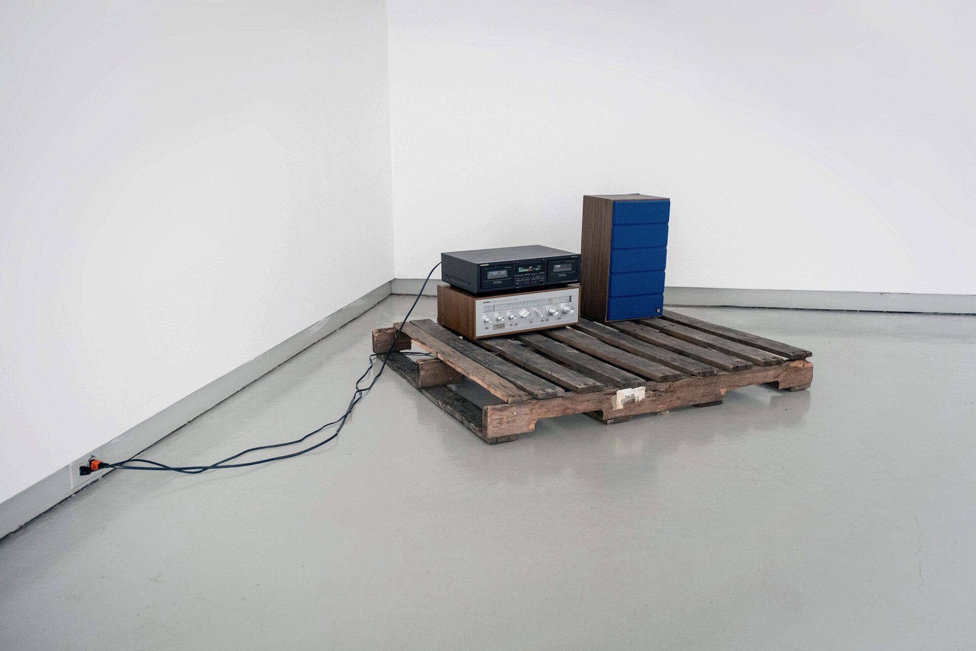 Miguel Mathias, “ The Shadow World “, 2022, Cassette player, pallet, receiver, speaker, 48” x 26” x 40”.