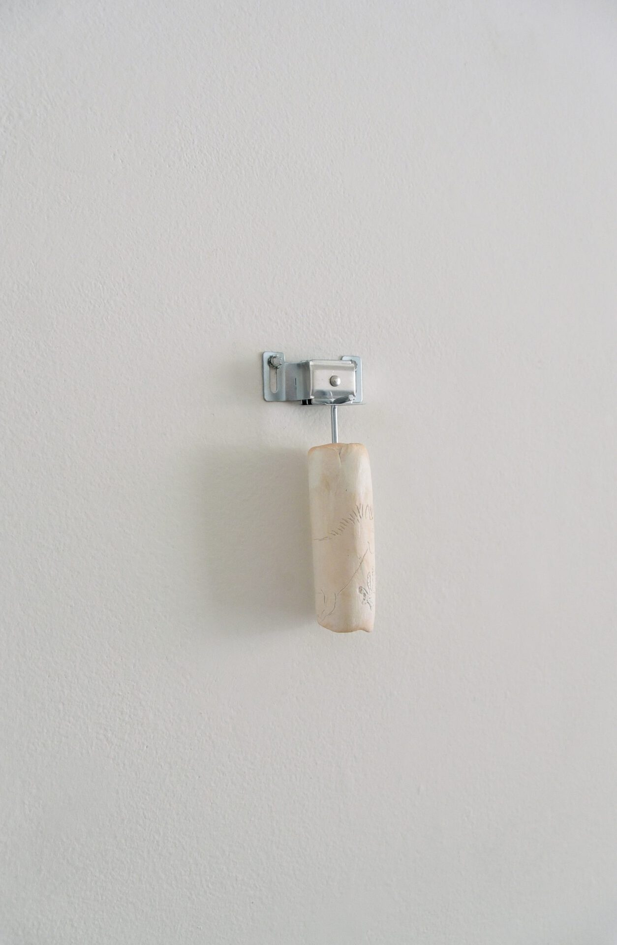 Brea Campbell-Stewart, Untitled ii (installation view), 2021, Clay and hardware, 1.5” x 6” x 1.5”.