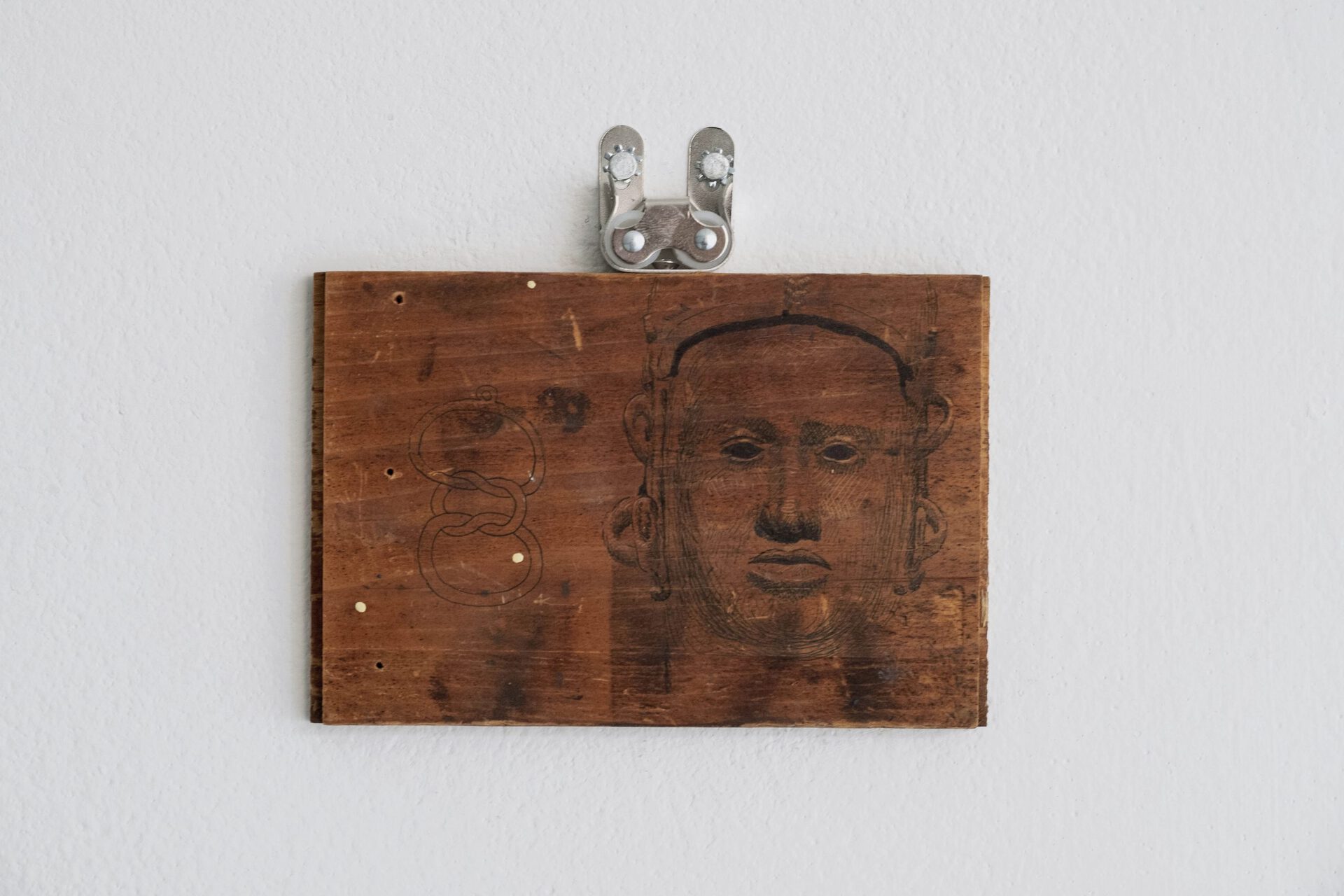 Jerome Sicard, Untitled, 2022, Ink on carved wood, hardware, 5.5” x 4.5”.