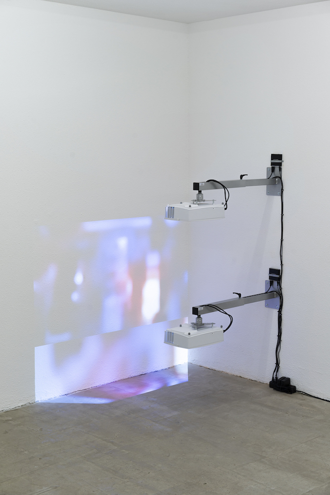 Milena Langer, Movies (Squint), 2022, 2 videos, 2 projectors, 2 wall mounts, 2 media players, cables