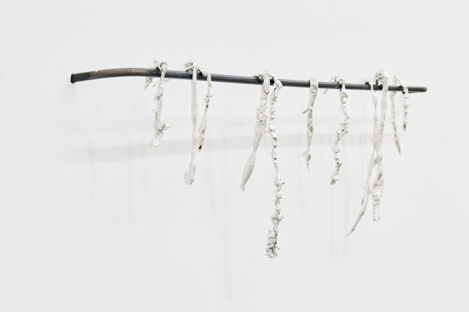 Luka Jana Berchtold, tears of tin (dry a.f.), 2022, tin, steel, 16 × 60 × 5 cm
