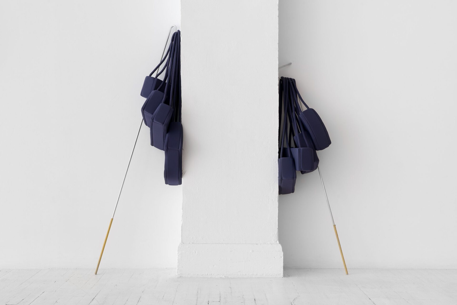 Kyle Alden Martens, 10 Purses That Form a Long Sleeve Shirt and Snake and Clothing Hooks, 2021, aluminum, leather, waxed cotton thread, jersey fabric, foam, rope, thread, variable dimensions