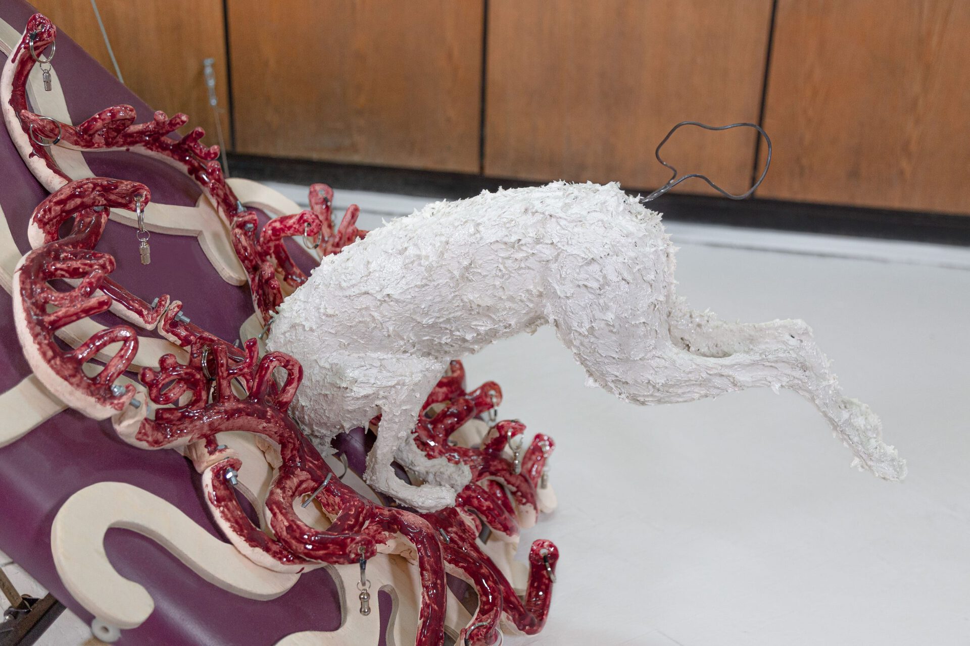 Stasia Grishina Space Dogs, 2022, massage table, plywood, glazed ceramics, styrofoam, gypsum, dog adress tags with key rings, wire, collar, steel cables, rigging; 180x70x60 cm