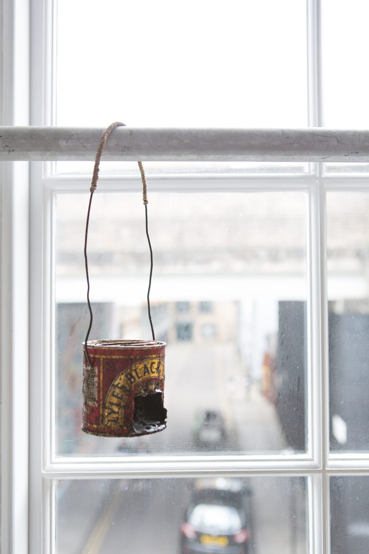 Tom Bull, Gone to the woods, 2022, edition of 6, black treacle tin, hay, wire, rope, candle, 30x8x78 cm