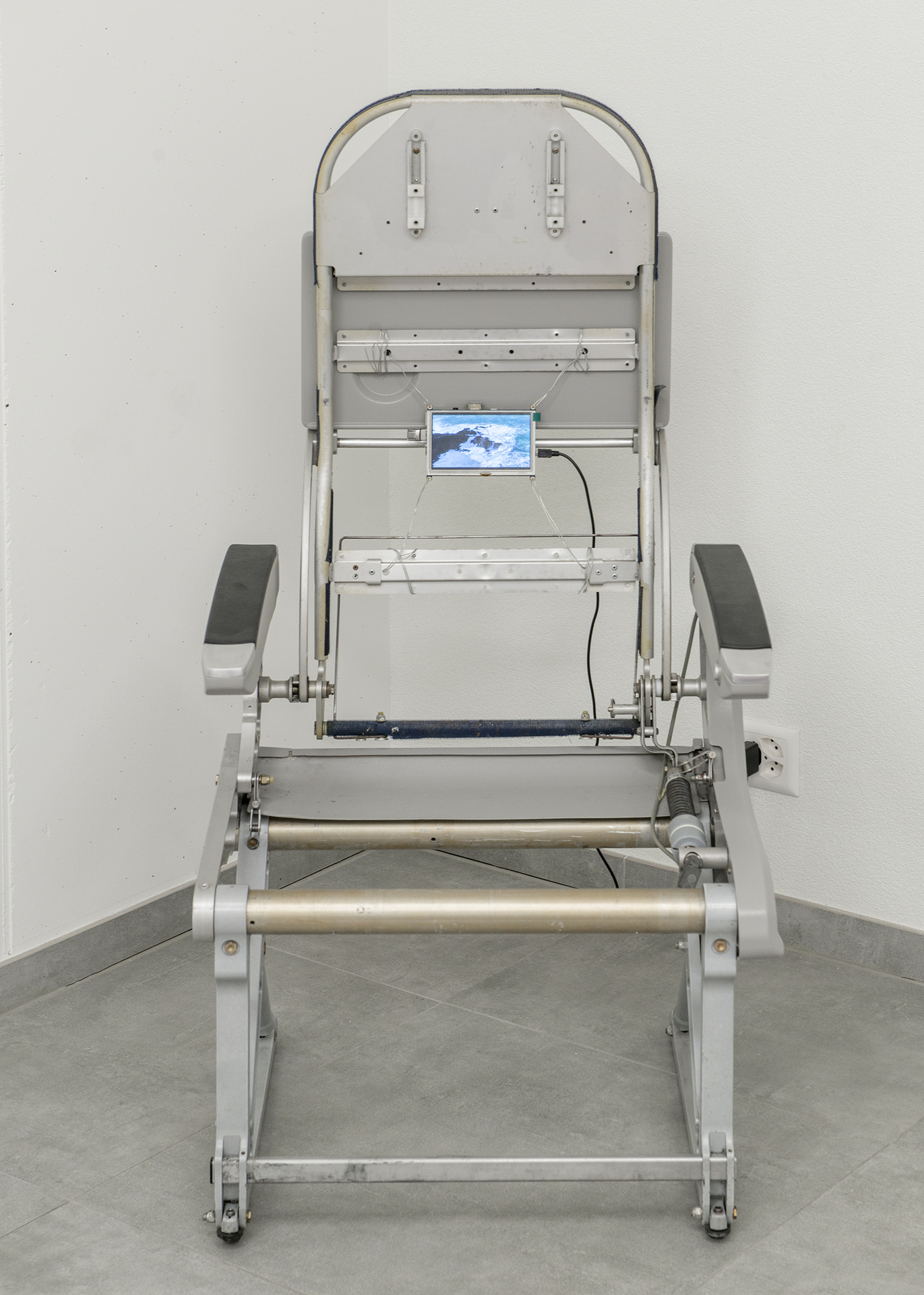 Rafik Greiss, Left to my own devices, 2021 airplane chair with video on LCD screen