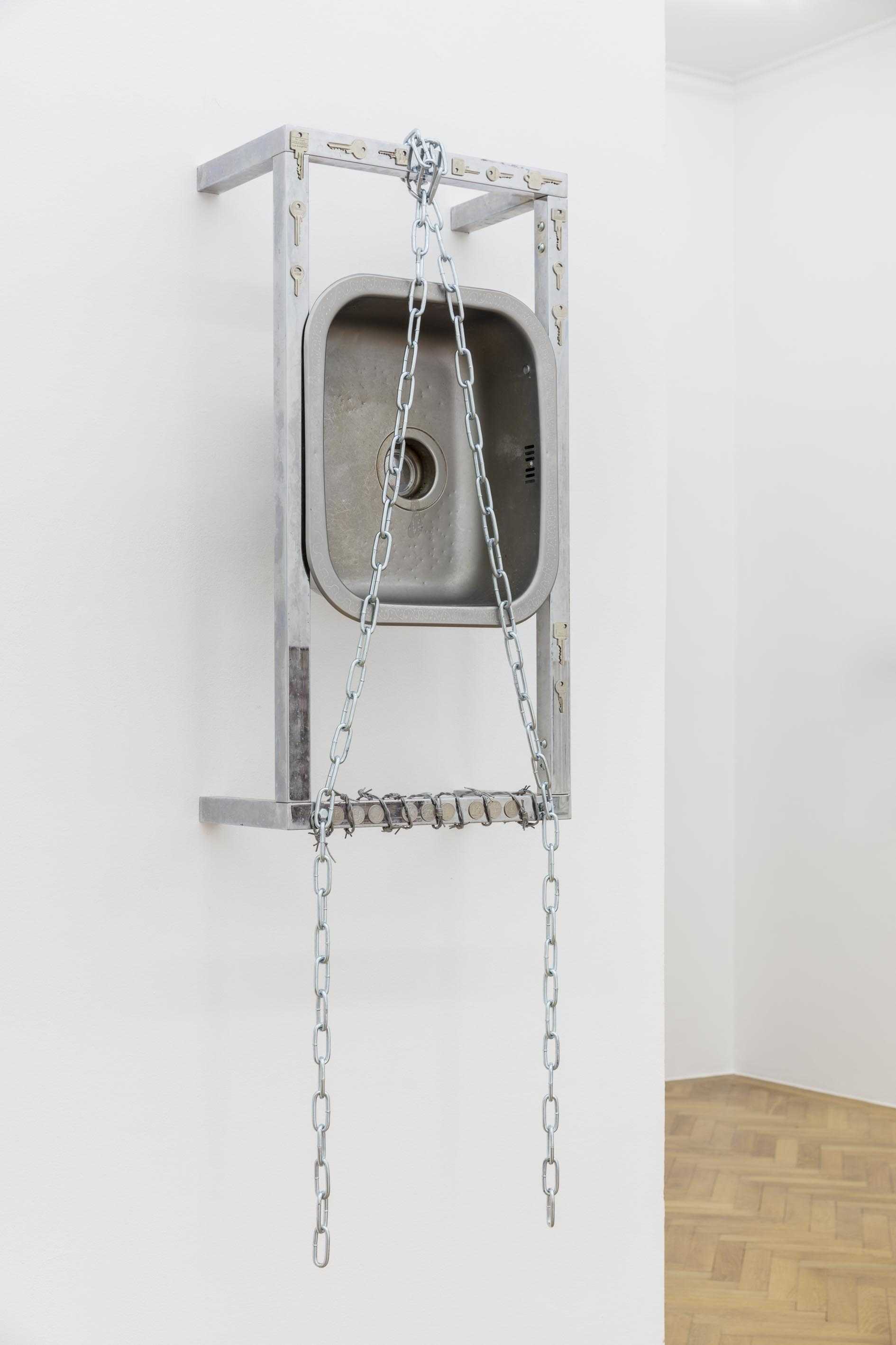Shackles / Kitchen, 2022, stainless steel, chrome, leather, coins, glue, bolts, wire, keys, 145 x 44.5 x 26.5cm
