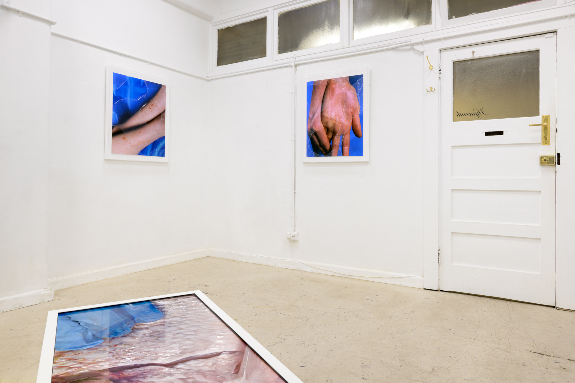 Installation view. Hydro-C-Zone, 2022, C-type print on Fuji Lustre, acrylic box frame, window film. Compulsive Reflex, 2022, C-Type print on Fuji Lustre, acrylic box frame, window film. Scintigraphy, 2022, HD video, LED TV, stereo sound, steel plinth.