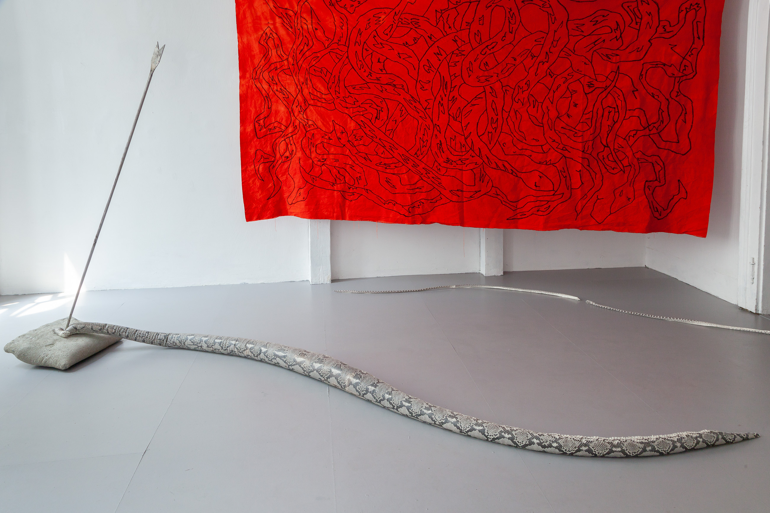 13 NicolÃ¡s Astorga, POSSIBLE ENEMIES, upcycled reassembled python skin, steel, concrete snake 3.5 mt / arrow 1.5 mt / pillow, 40 x 40 x 10 cm, 2021Â 