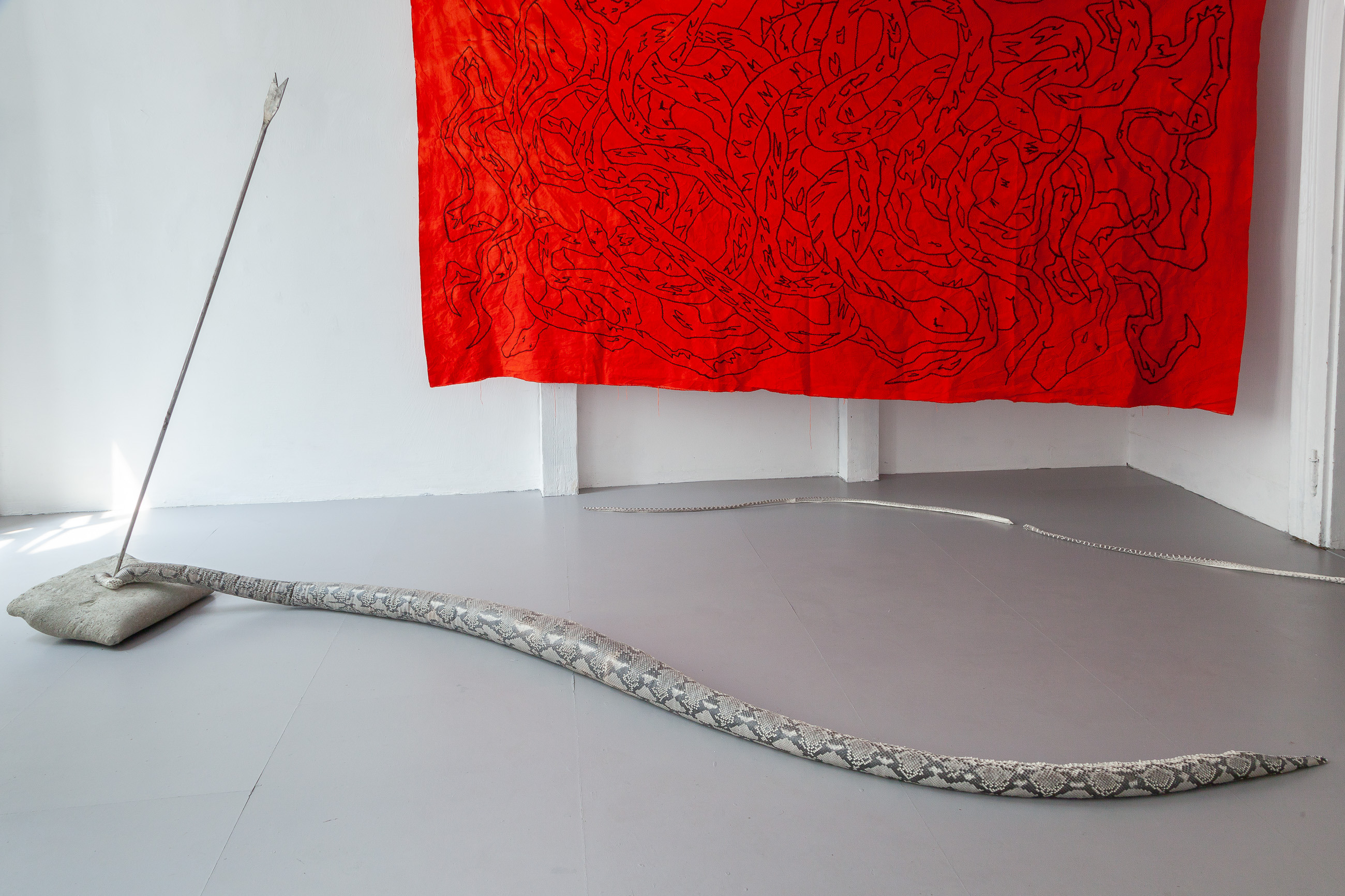 13 Nicolás Astorga, POSSIBLE ENEMIES, upcycled reassembled python skin, steel, concrete snake 3.5 mt / arrow 1.5 mt / pillow, 40 x 40 x 10 cm, 2021 