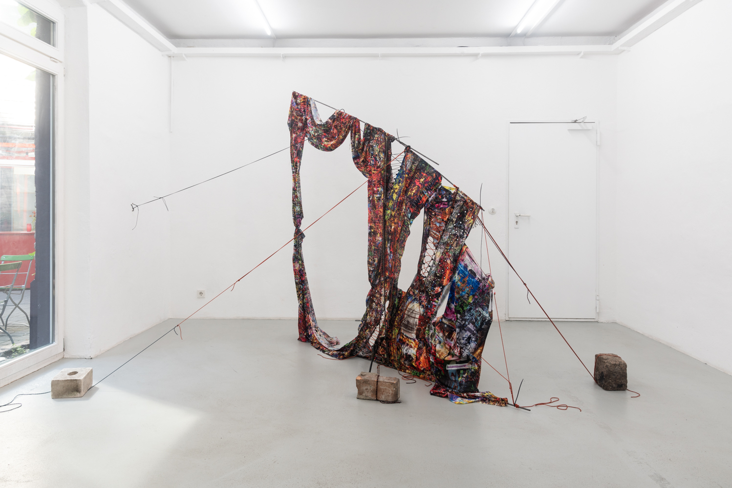 Tanat Teeradakorn & Joe Highton GEOMETRY OF THE DELUSIONAL LAYER ON THE BONE, Dye-sublimation print on fabric, metal, ropes, rocks; 2m x 2m 2022