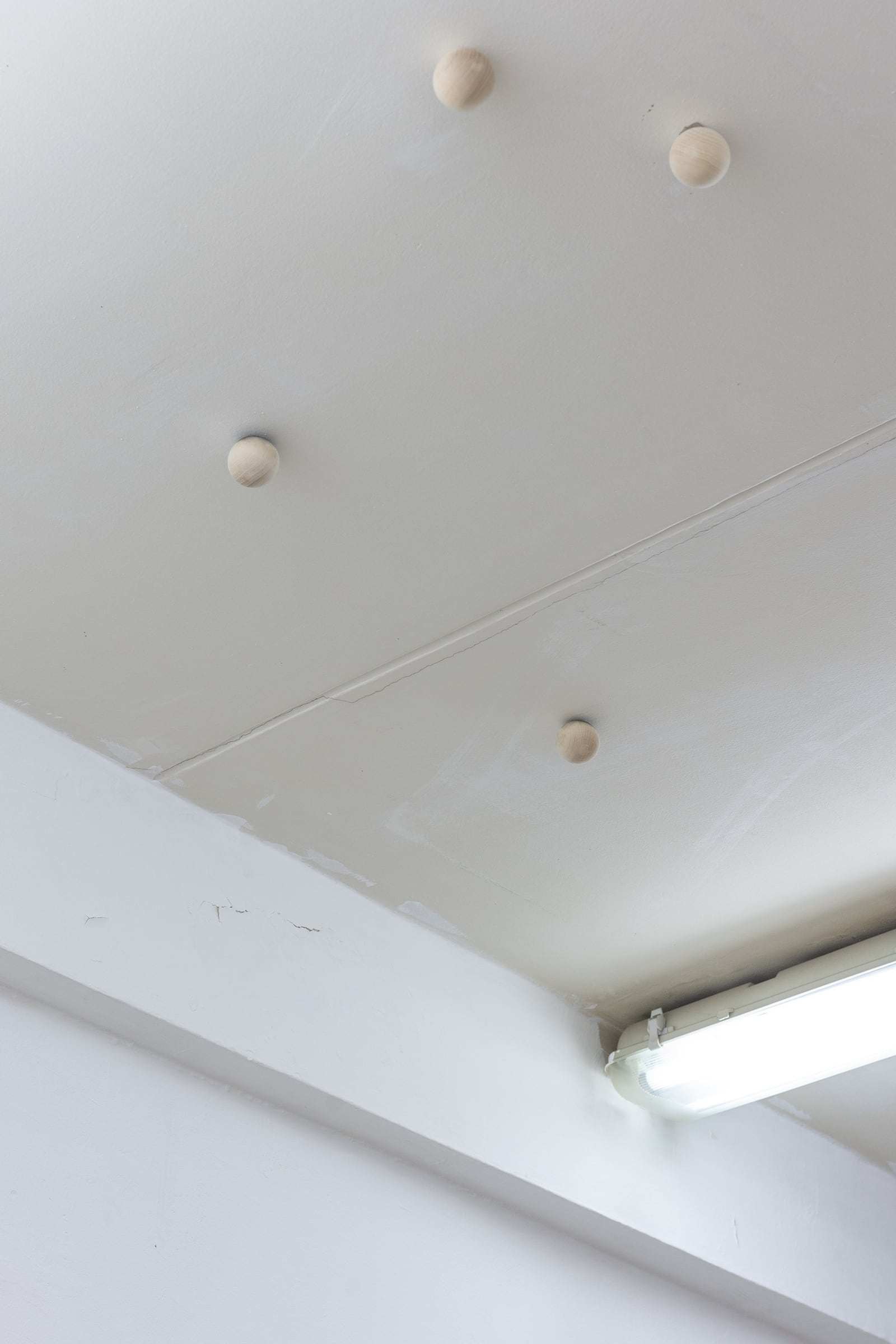 Ben Sang, untitled (spheres), 2022, wooden spheres attached to ceiling, dimensions vary