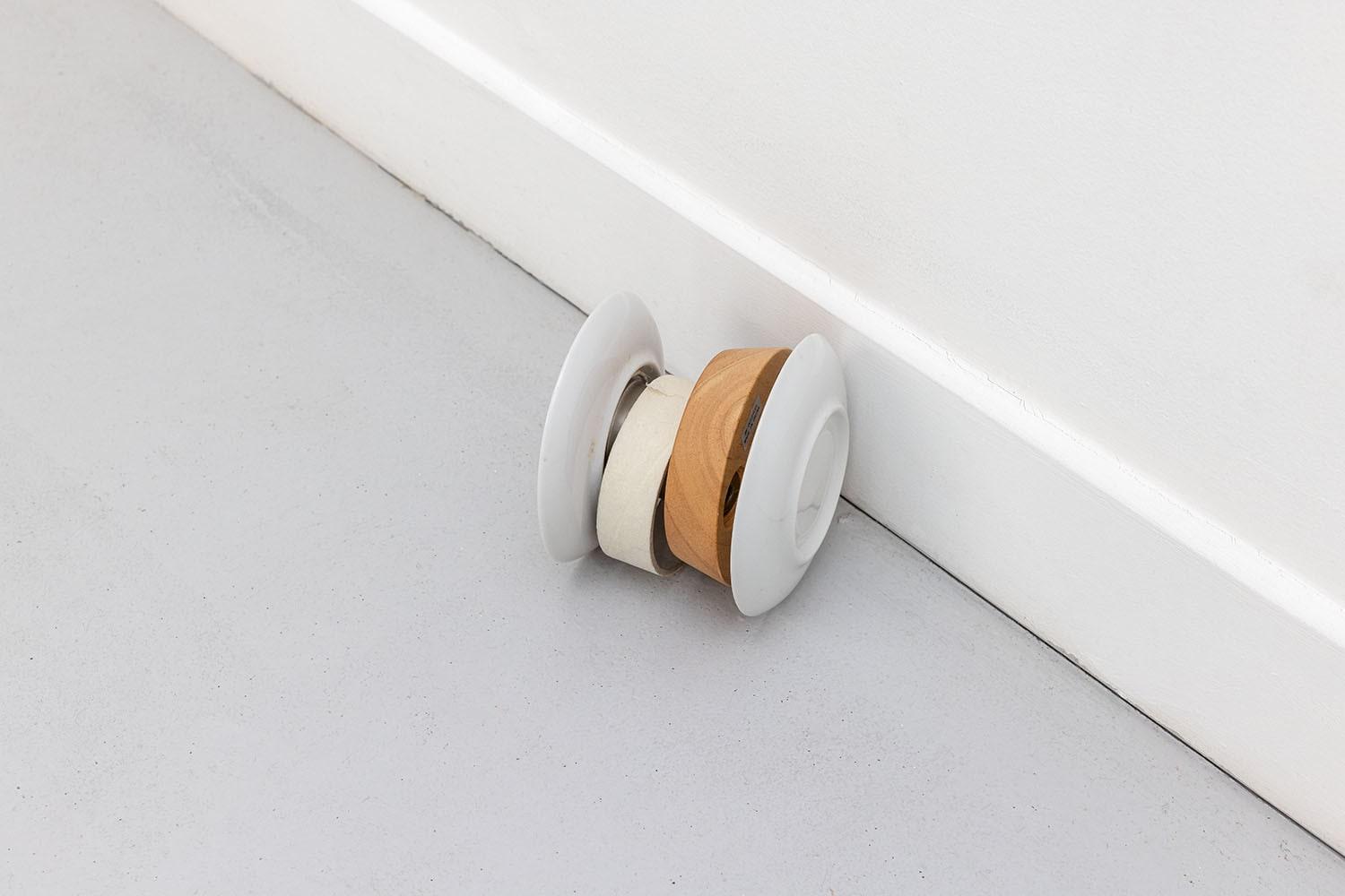 Objet repère ?, 2022, plates, IKEA lamp base, roll of painter's tape, glue, 12 x 12 x 11 cm