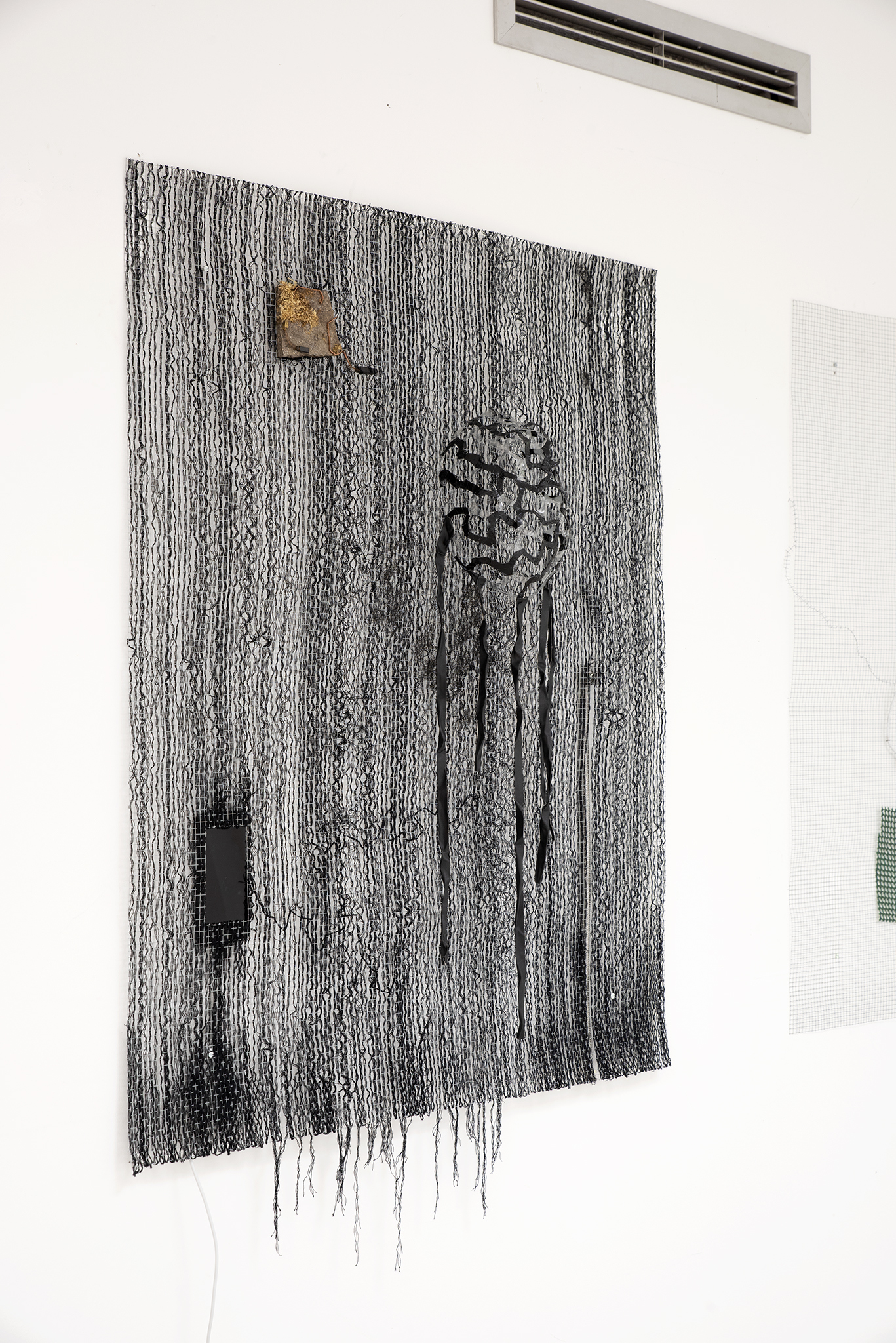 Maxine Weiss, People look like ants from above here (2022), found objects, wool and video (3.10’) on wire mesh