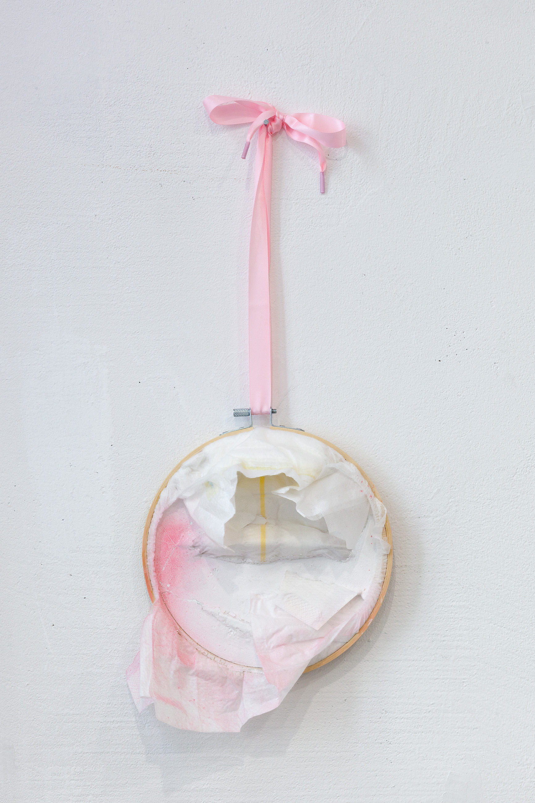 02. Paula Linke, Proletarische Gegenentwurf Dream, embroidery frame, diaper, cement, spray paint, shoelaces, cellophane, sticker, water colour, 2022