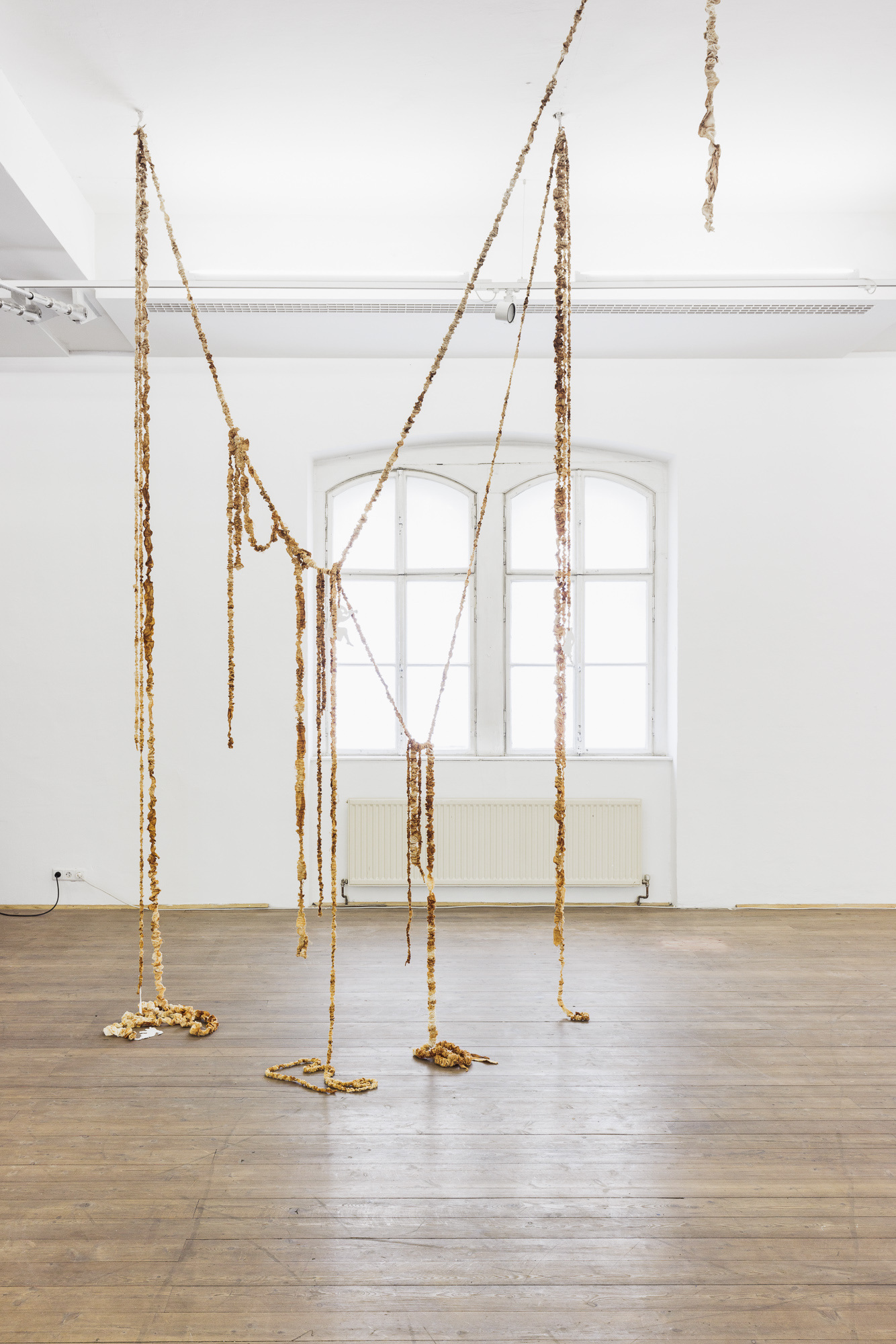 Antonia Boss DRAPE, 2022 textile installation of rust coloured elements, various dimensions