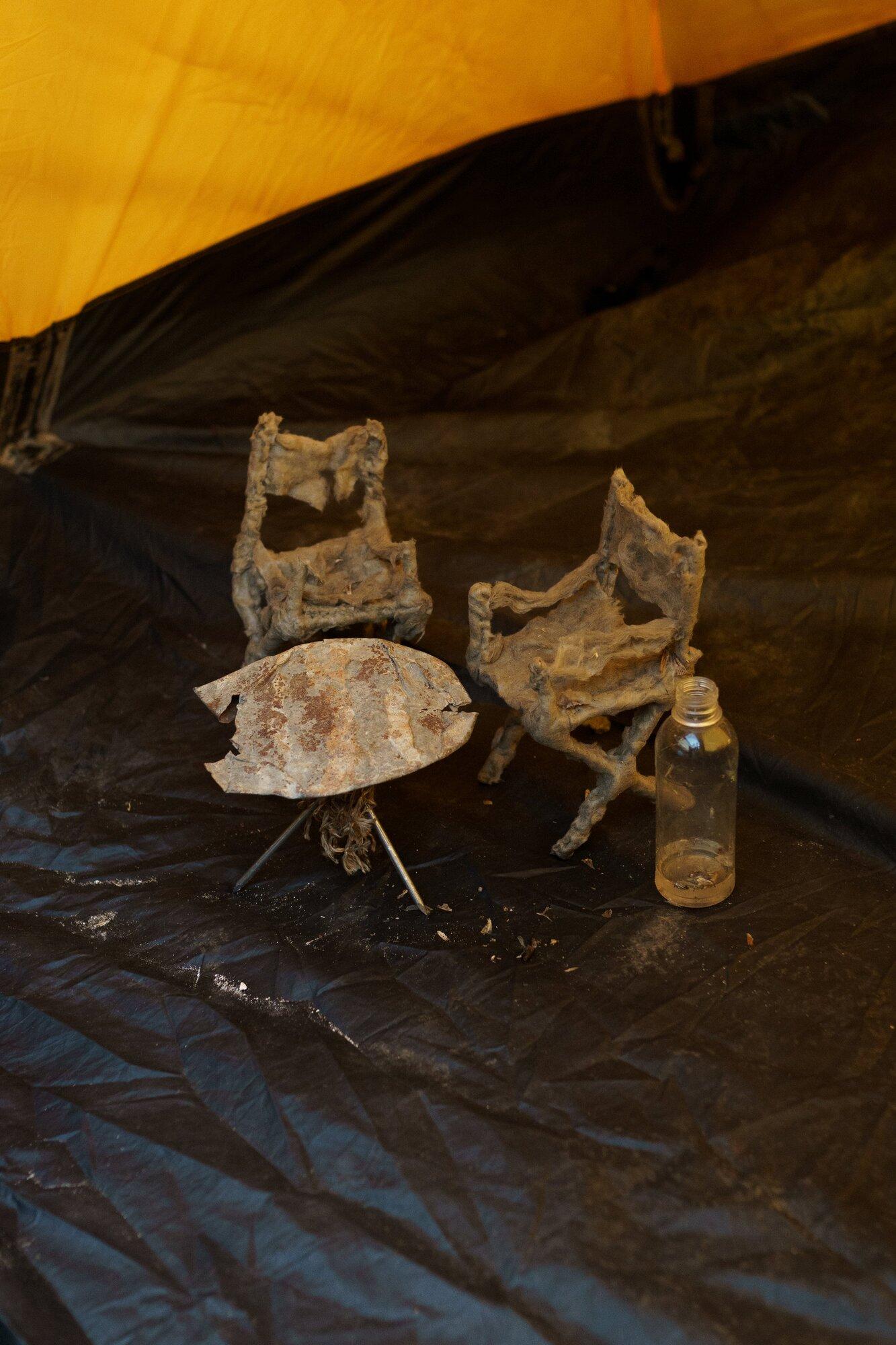 Zukhra Salakhova, Breakfast with a view of Elbrus, 2022, basalt wool, wood, nails, thread, metal, fishing net, bottle, water, moths, dimensions vary