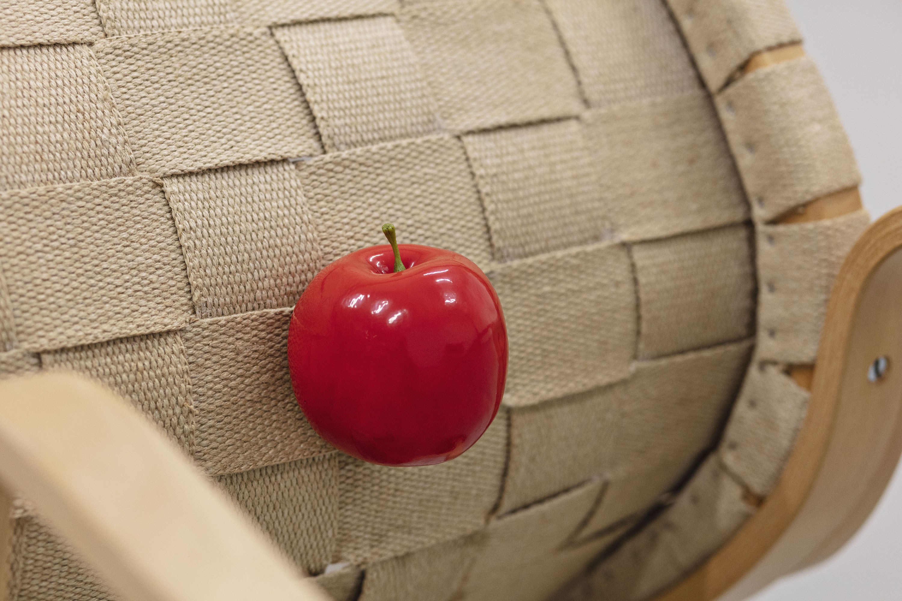 Tora Schultz: Positions (detail), 2022. EVA Chair in bent beech by Bruno Mathsson, apple, EvaRid shoes Bates Oxford size 7.5; 95 x 70 x 50 cm. Photo: Laura Stamer