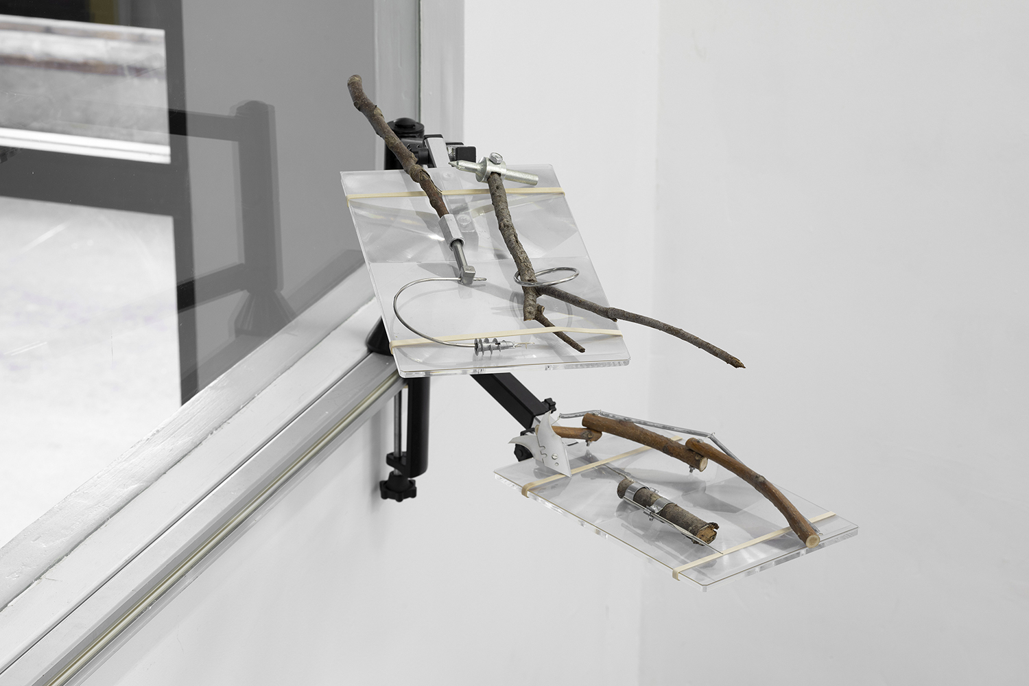 Lee Nevo, The Unofficial Office for Removal of Rebellious Moral Issues, 2014. Adjustable monitor arm, magnifying sheets, metal parts, rubber bands, wood, variable dimensions