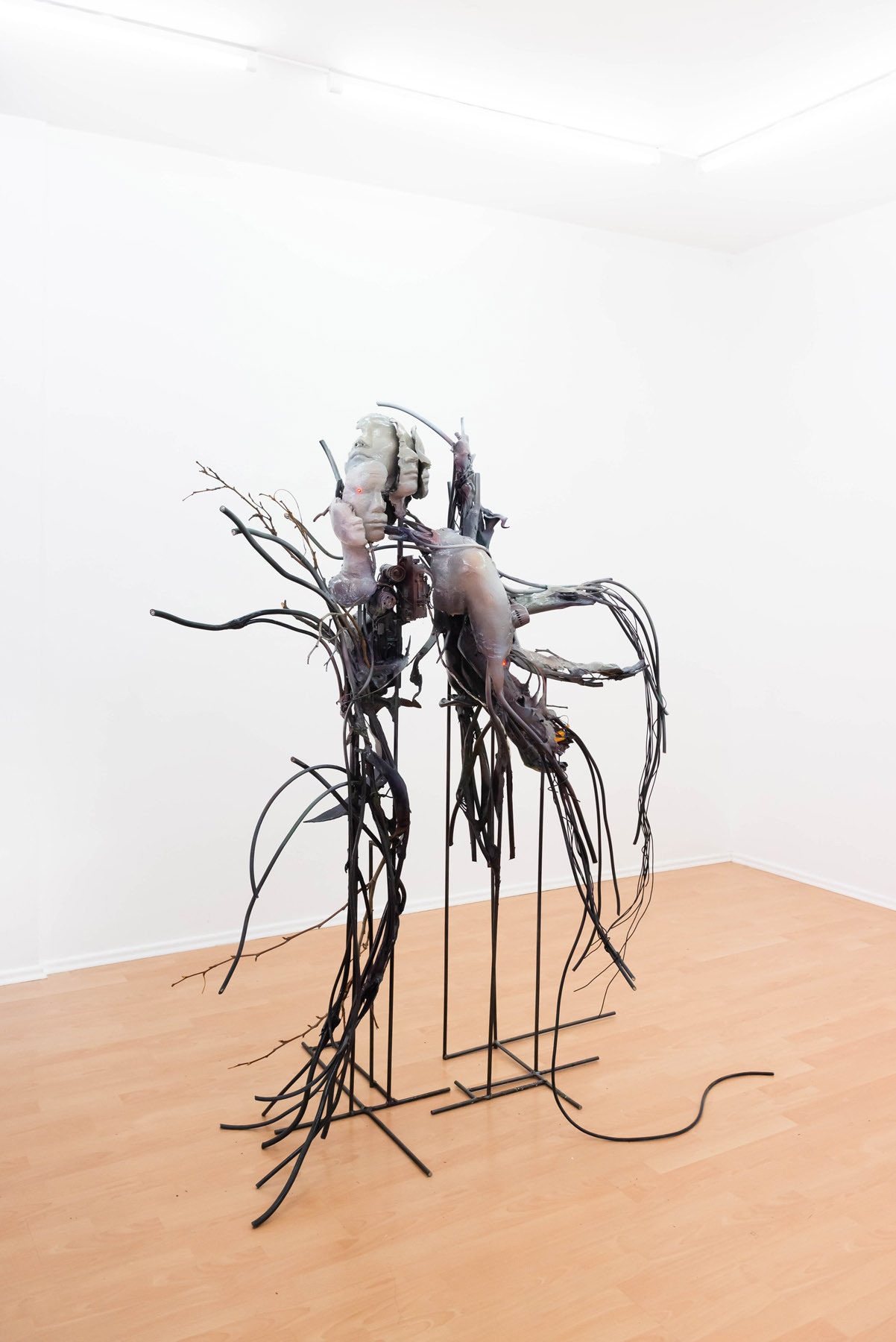 Yein Lee. devouring chaos - growth of reconstructed time, overflowing bodies, and static electricity, 2022, brocken chain saw, drill motor, mixer motor, fake flower, dry branches, electrical wire, polymer gypsum, epoxy putty, steal, acrylic color, lacquer