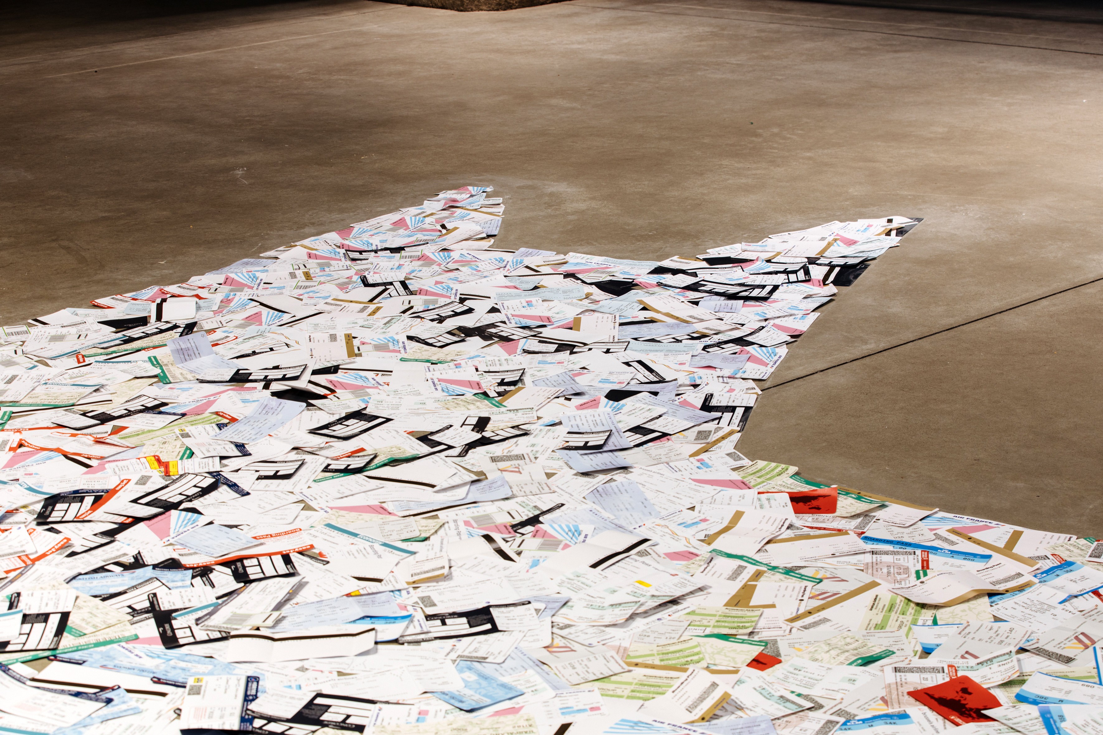 empty seats - 2022 - material: about 5000 replicated airplane tickets of different airlines, patafix glue pads, 1100 × 1 × 547 cm