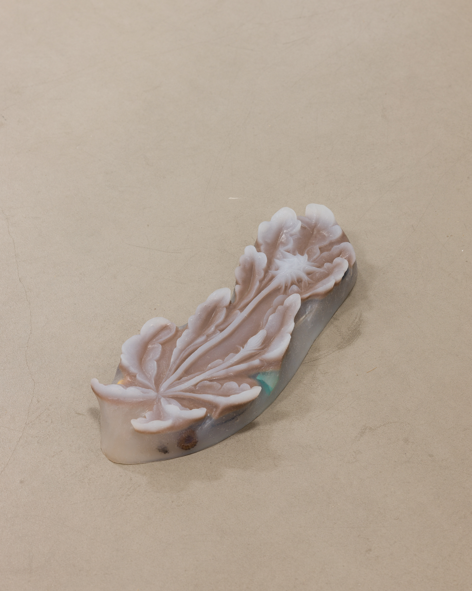 ASMA, "Mud keeper", platinum silicon, fly, headphones, juul capsule, metallic found objects, 2022