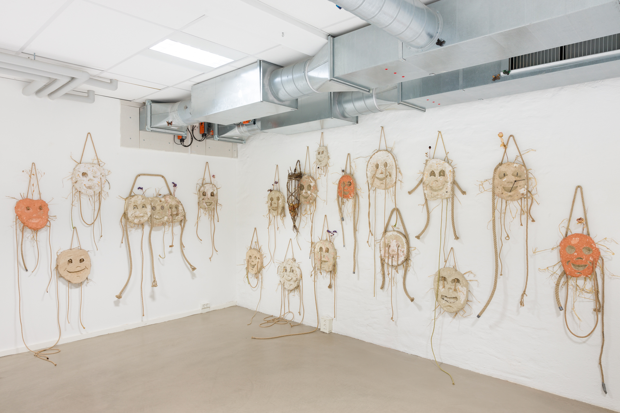 Lars Worm, "Born Happy", plaster, clay, rope, straw, flowers, rocks, brass, plastic, acrylic paint, 2021-2023