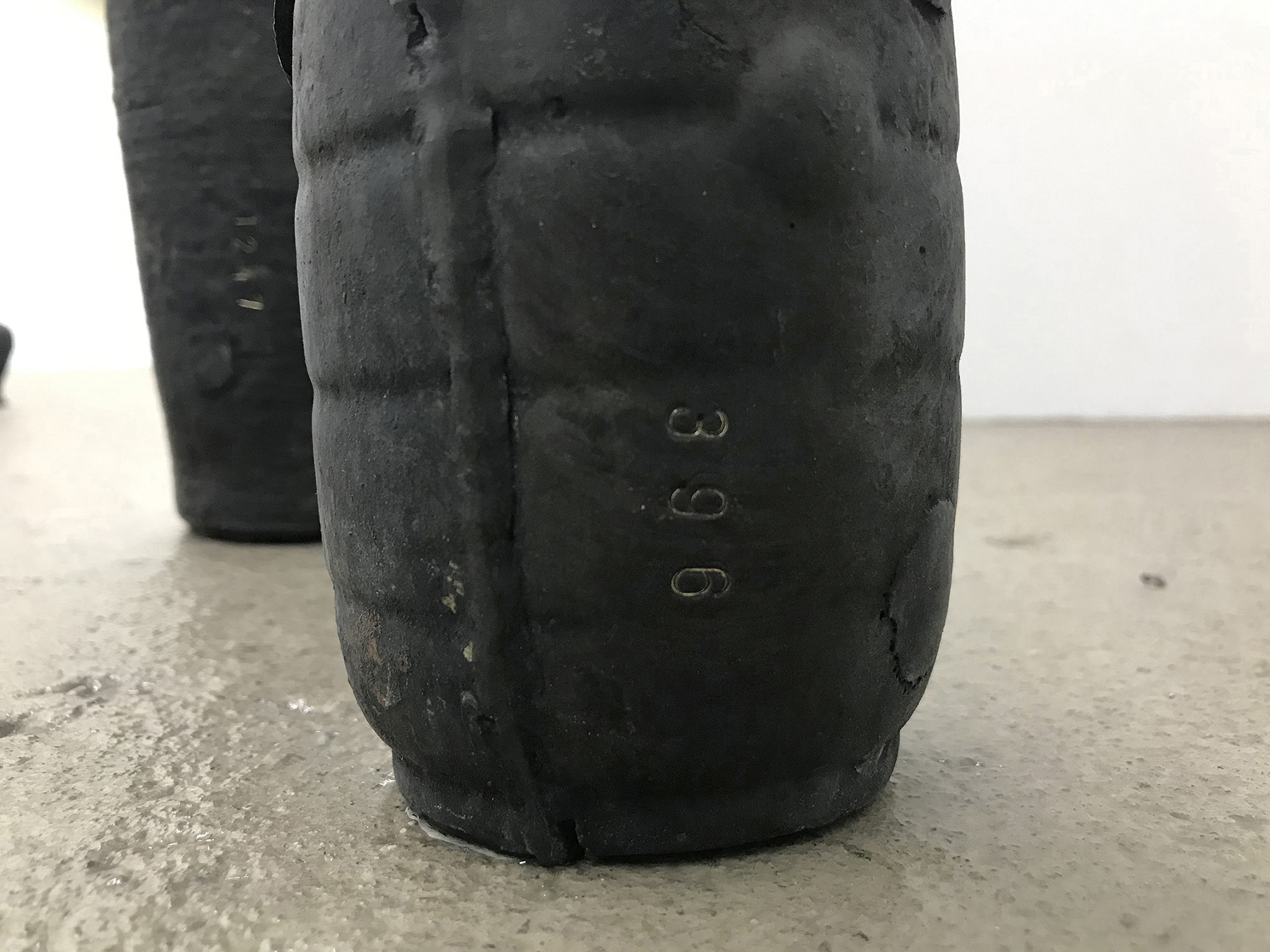 Urn detail, stamped with the number of AR-15 casings used in its casting