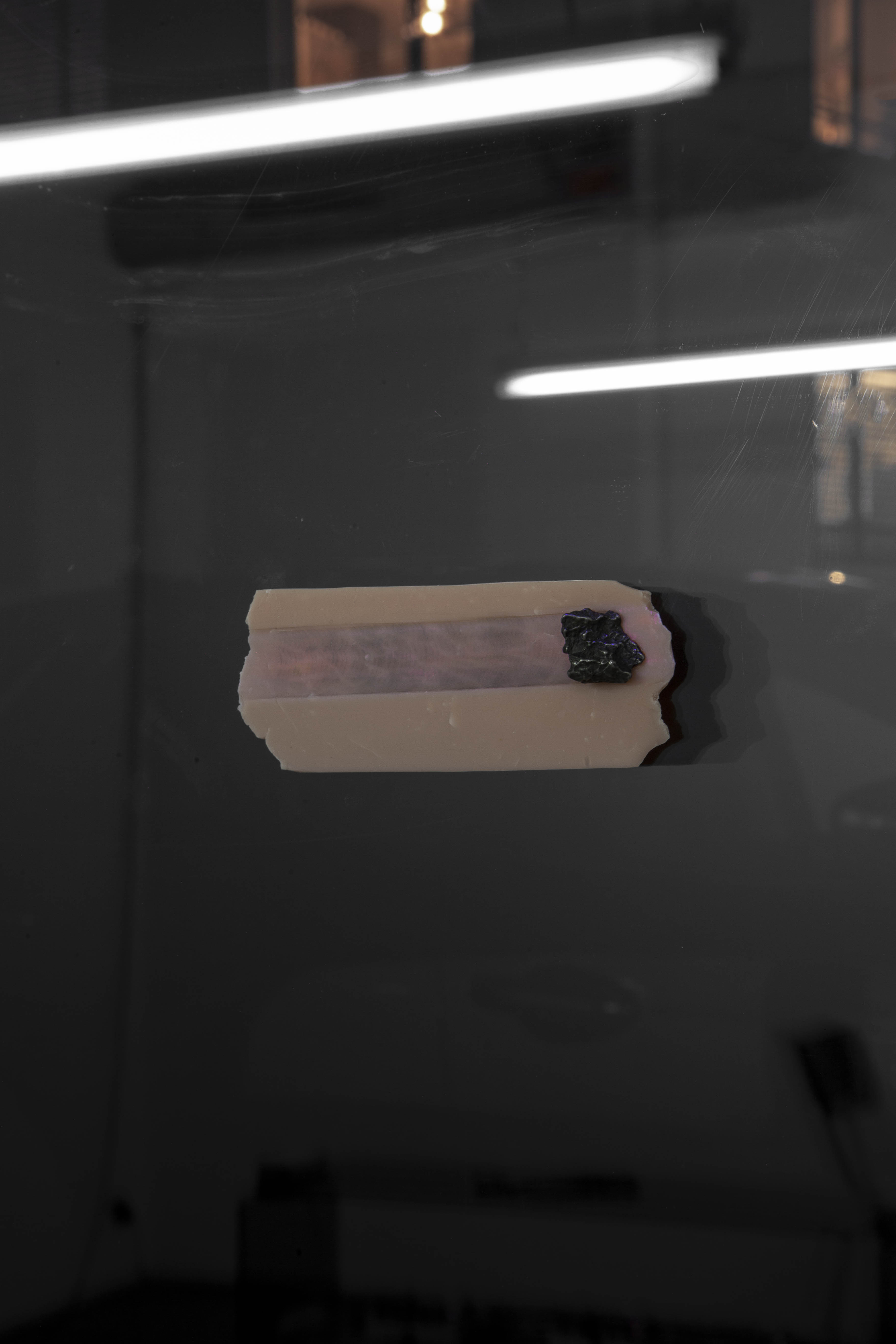 Death, 2023 Meteorite fragment, sculpy, magnet, 405 nm laser