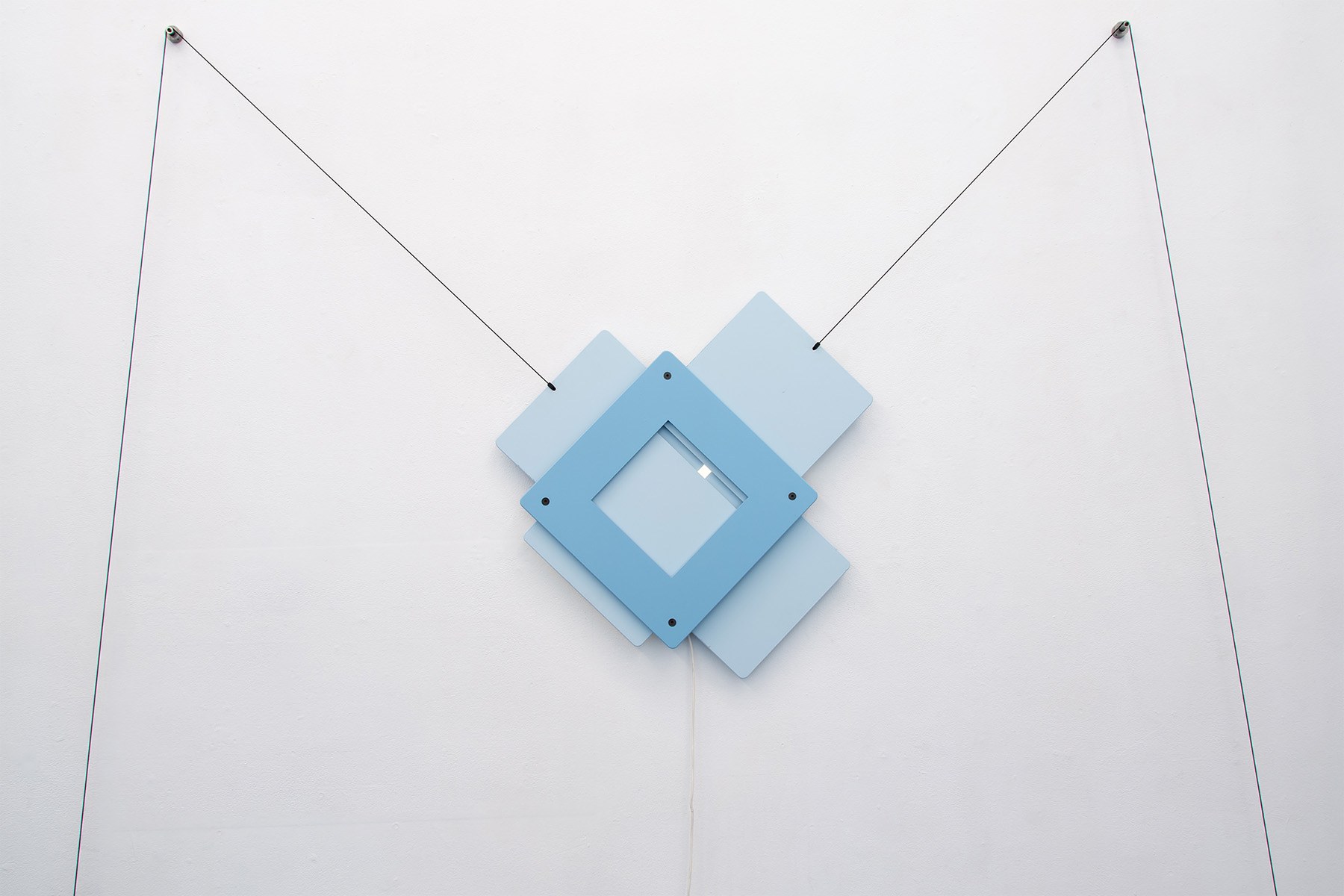 Screensaver, 2023, motor, MDF, water based paint, sand lime brick, tension strap, dyneema rope, bearings, steel, led