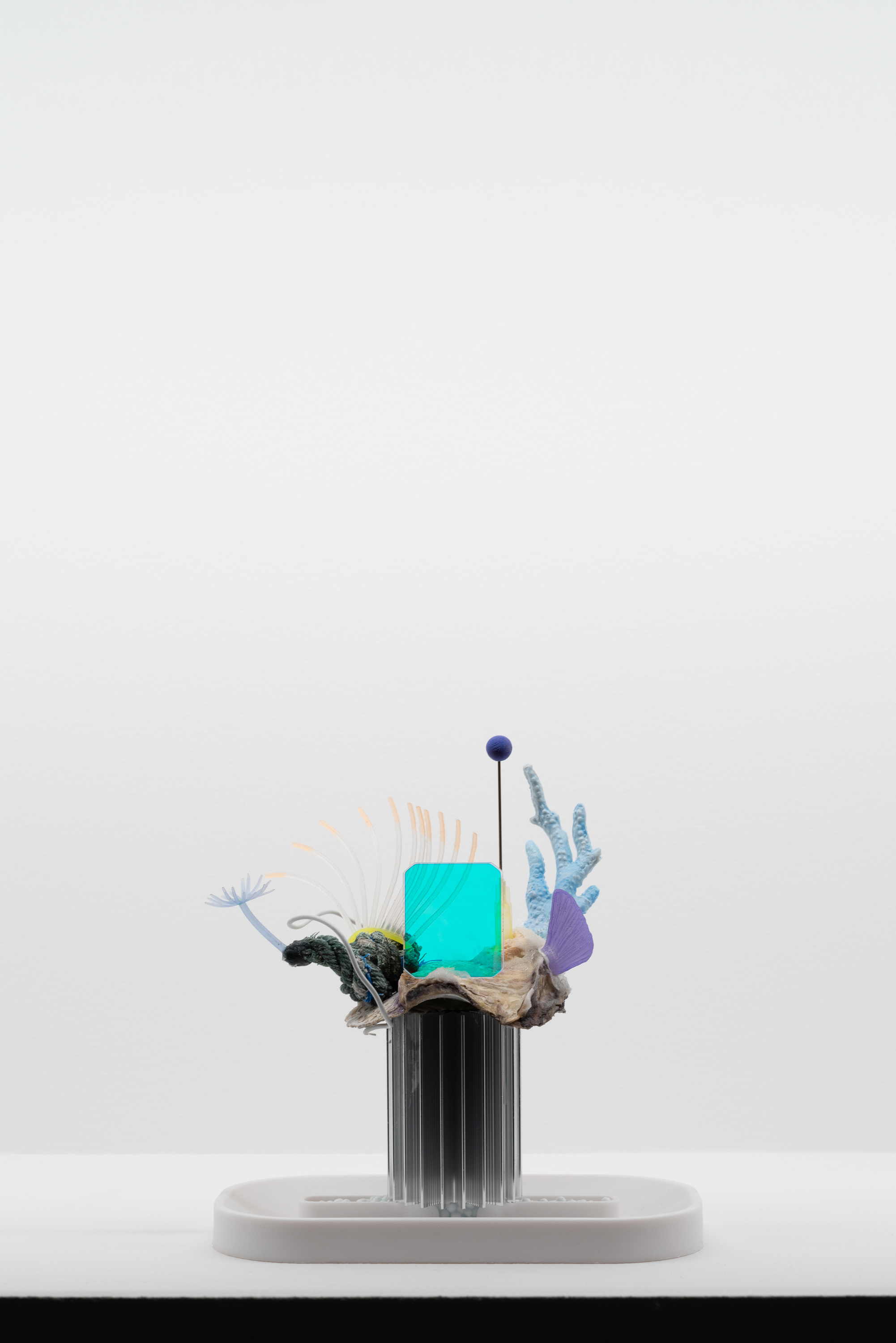 Théo Massoulier 5G, 2021 Ceramic, coral, plastic fragment, dichroic glass plate, dried plant, mineral, 12 (L) x 8 (W) x 8,5 (H) cm. Photo/ Adrien Thibault. Courtesy of the artist and HATCH. 2/6
