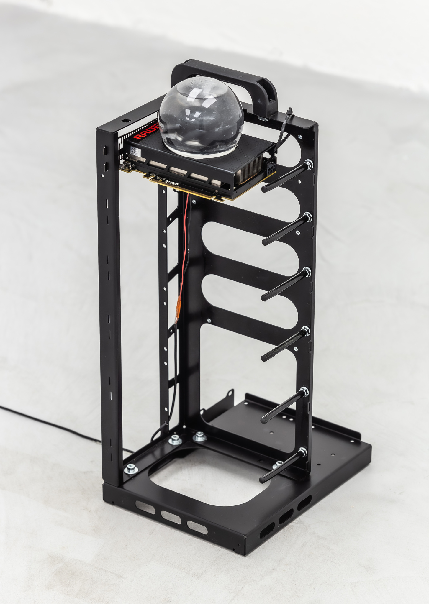 Rémi Lécussan Snown mining rig, 2022 AMD Radeon R9 Nano graphics card, blown glass globe, mineral oil, artificial snow, mining rig support, 28 x 22 x 57 cm